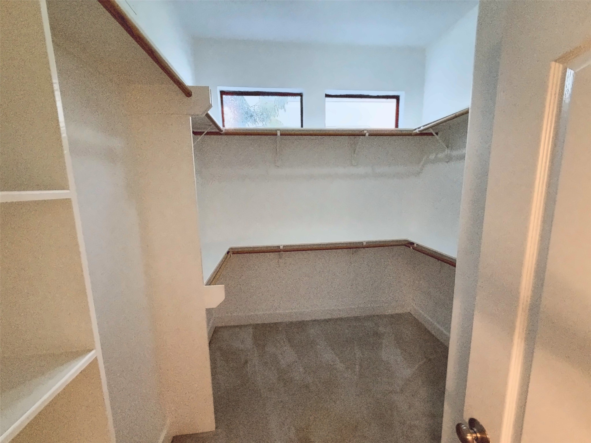 Primary closet with built-in shelving.