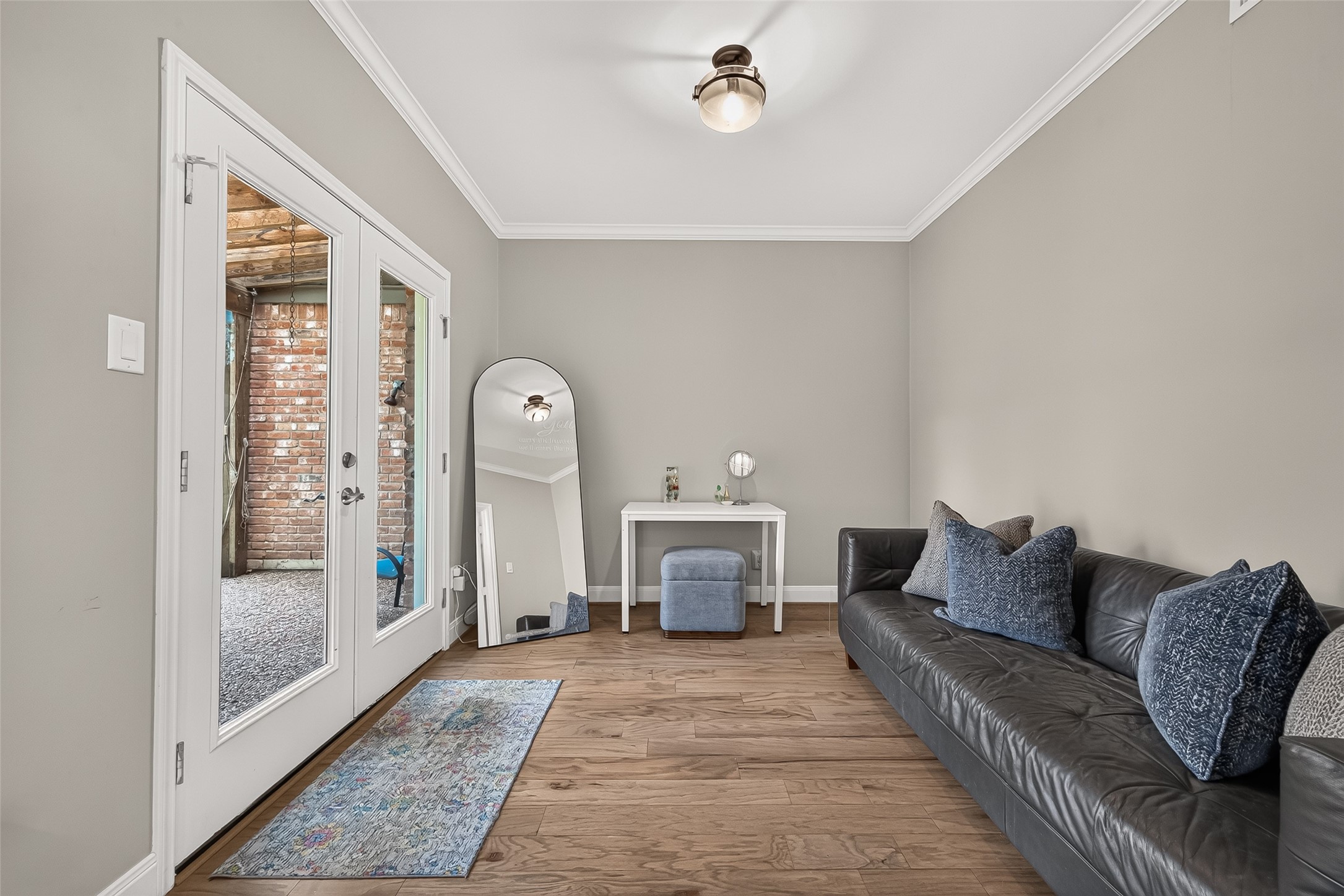 Sitting room off the primary bedroom. The French doors lead to the backyard.