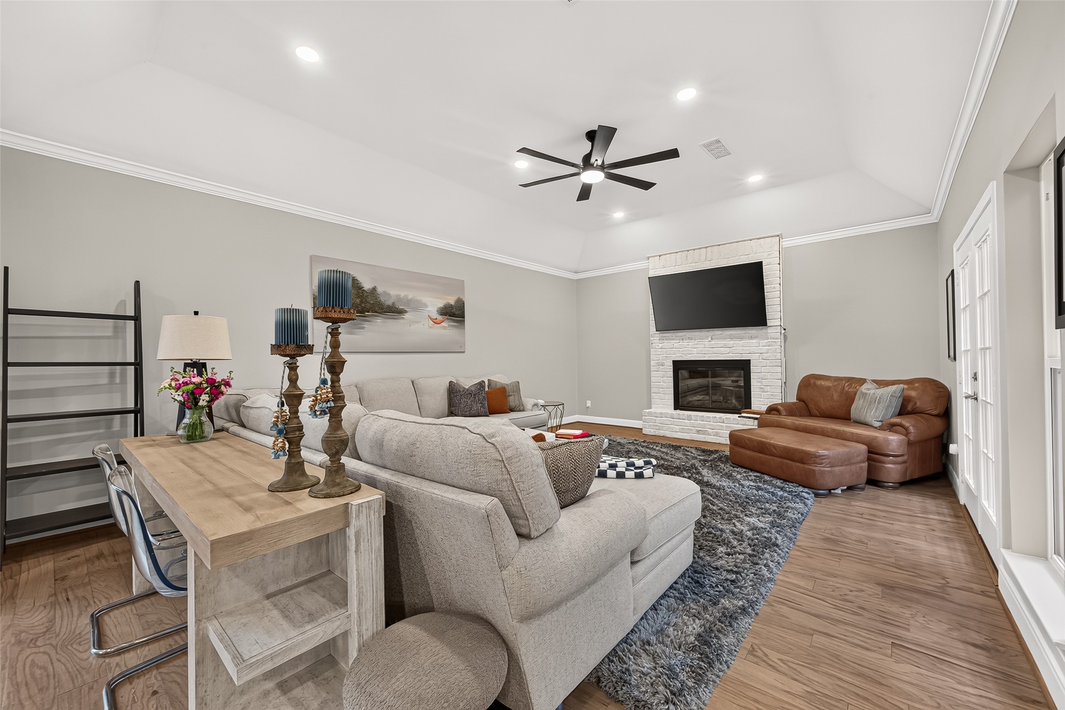 Another view of the living room showing the cozy fireplace.
