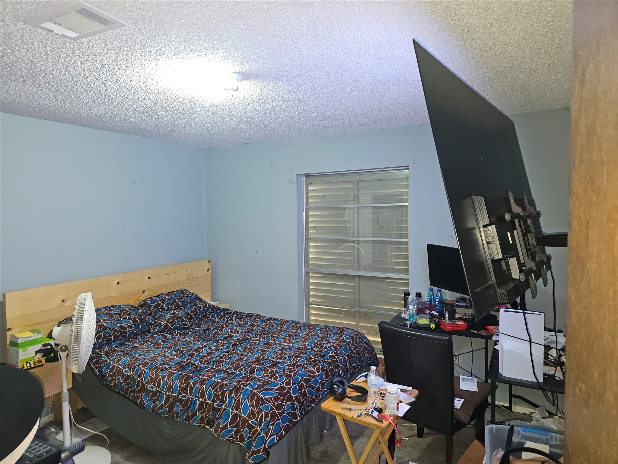 Comfortable secondary bedroom with soft carpeting, neutral finishes, and a spacious layout.