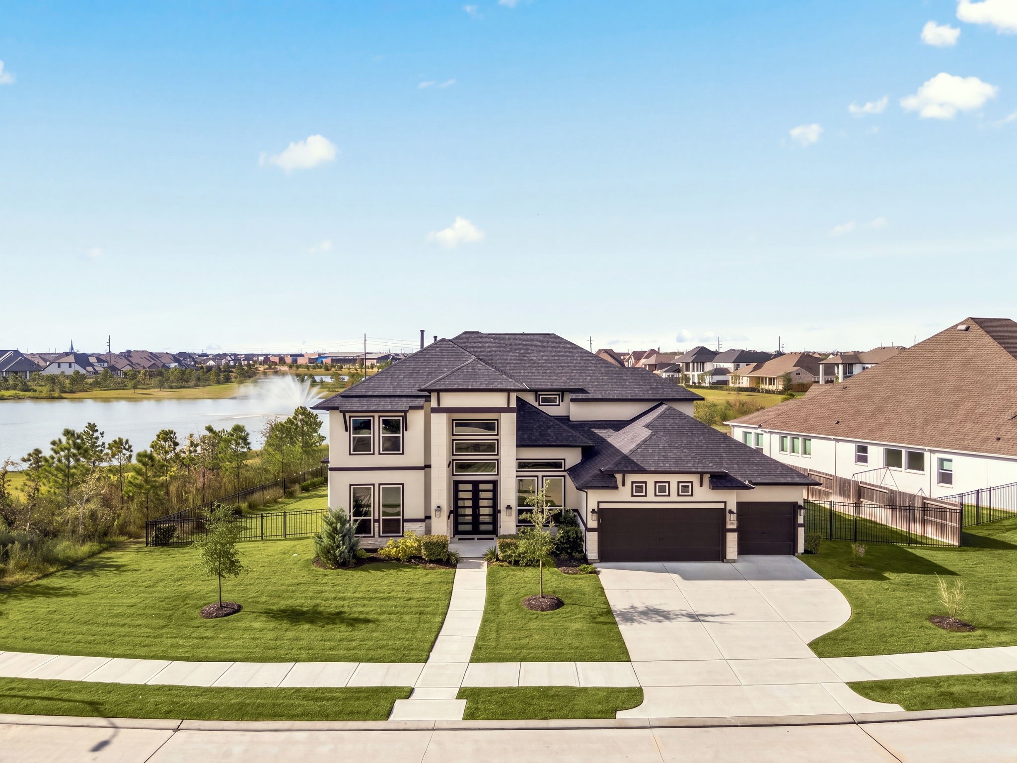 An elevated J. Patrick Homes exterior showcasing upgraded architectural details, striking curb appeal, and an impressive four-car garagewhere luxury, design, and functionality come together beautifully.