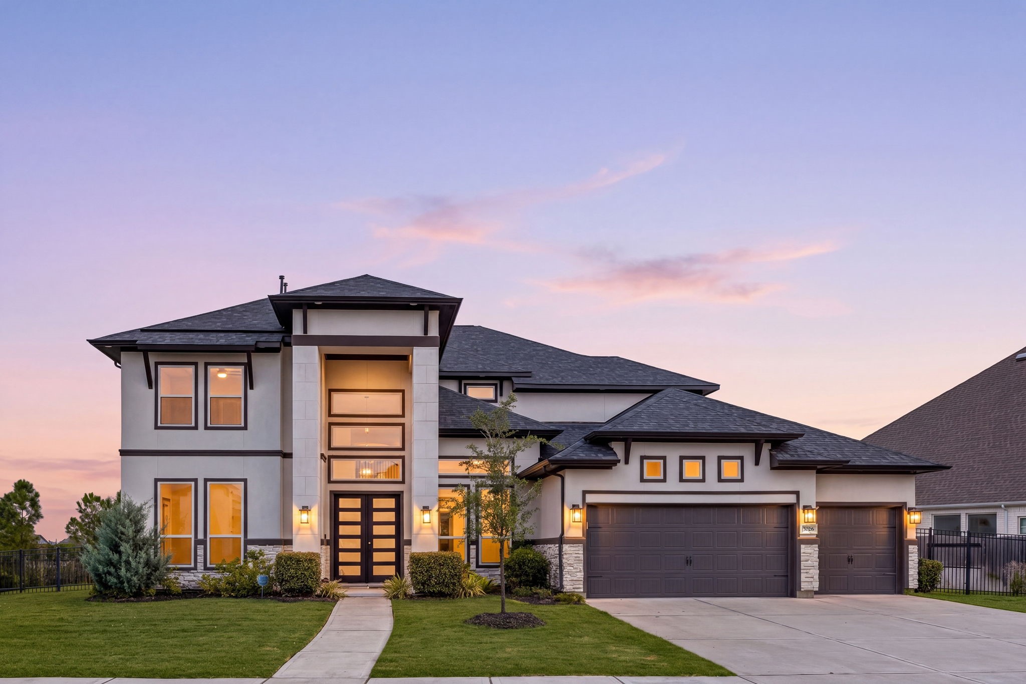 Luxury shines after sunset. Experience the beauty of this extraordinary J. Patrick Homes residence, where elegant architecture and enchanting evening ambiance create a truly captivating welcome.