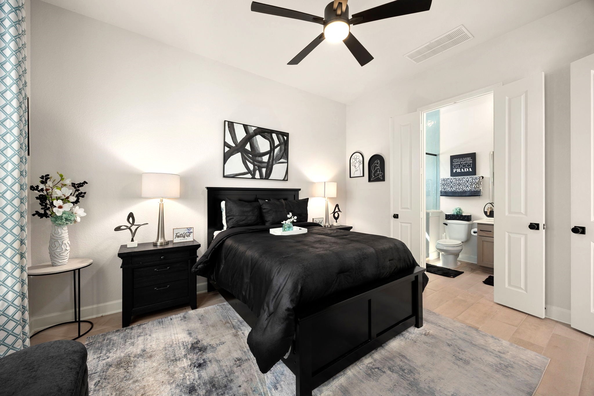 A private downstairs guest suite features elegant double doors leading to its own ensuite bathroom and dedicated closet, offering exceptional comfort, privacy, and convenience for overnight guests or multigenerational living.