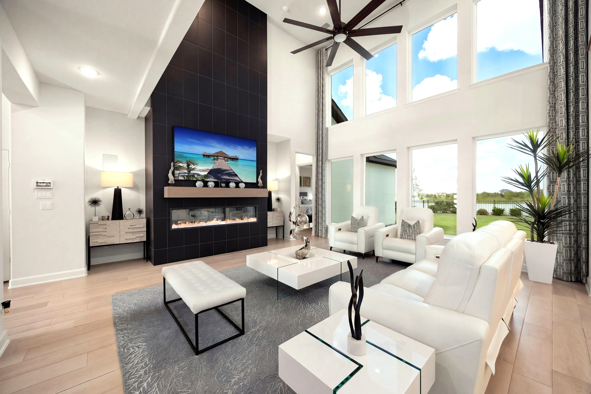 A stunning electric fireplace framed by floor-to-ceiling stone tile creates a dramatic architectural focal point that elevates the living space with modern luxury and timeless sophistication.