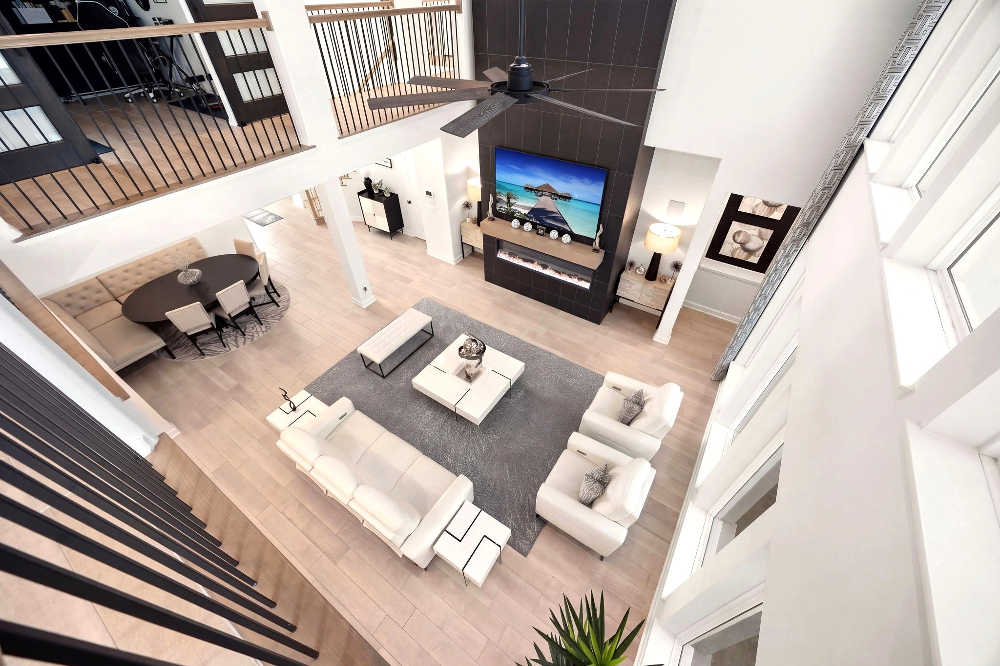 An elevated view highlights the sleek electric fireplace, floating mantel, and custom floor-to-ceiling tilework, creating a striking modern focal point that adds depth, texture, and upscale sophistication to the living space.