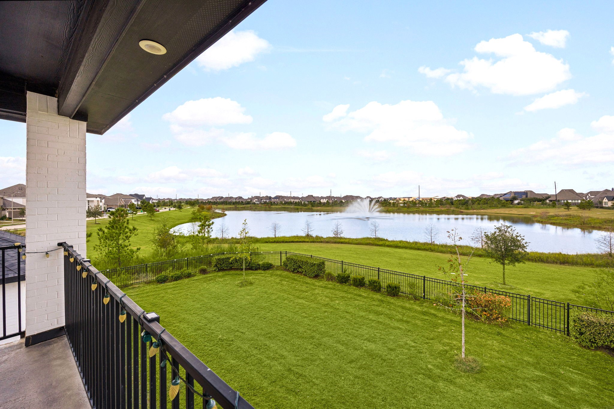Enjoy breathtaking lake views from the second-floor covered balcony, an elevated outdoor retreat perfect for morning coffee, sunset relaxation, and sophisticated entertaining against a serene waterfront backdrop.