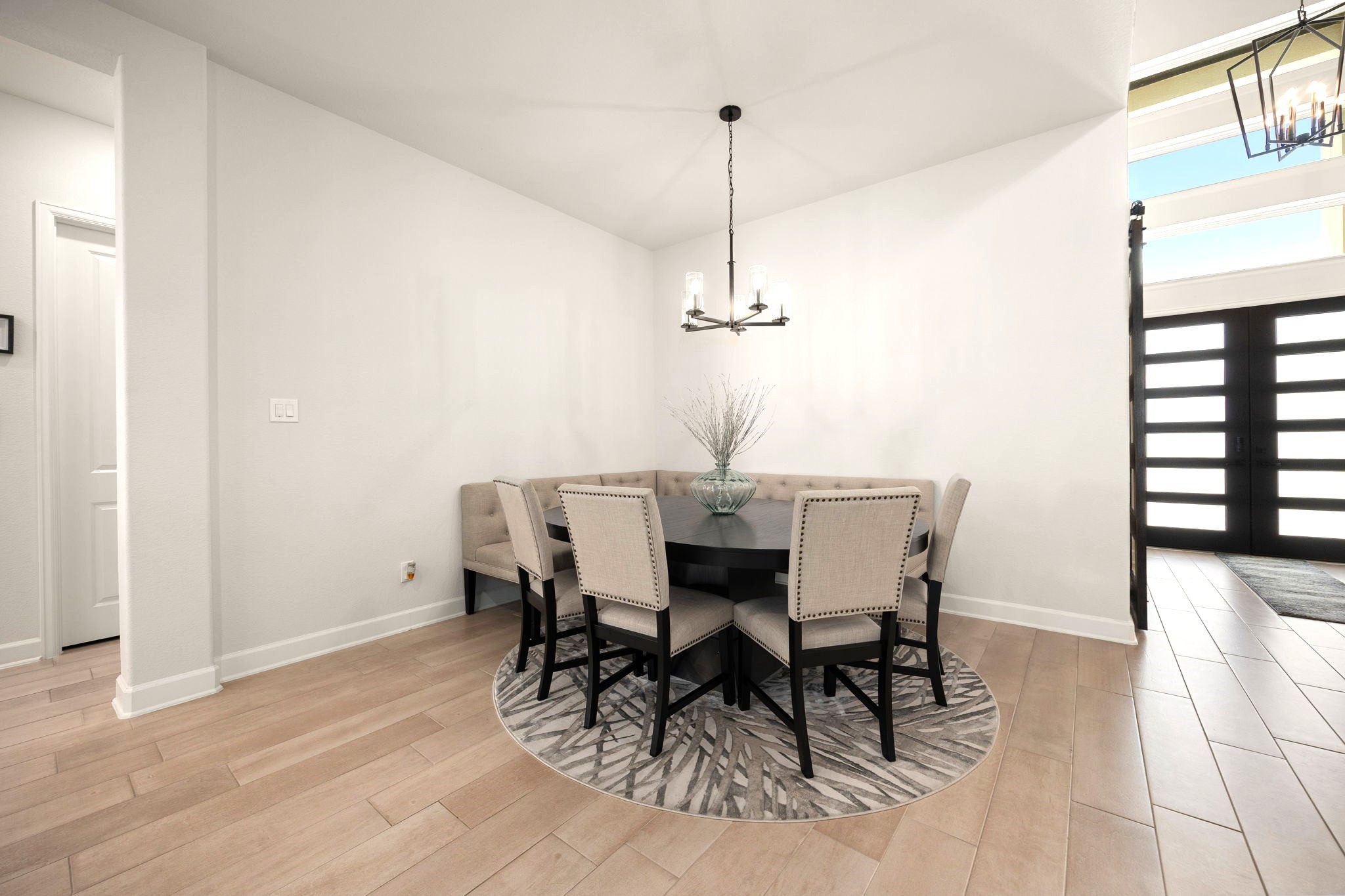 An elegant formal dining space seamlessly flows into the open-concept living room and upgraded kitchen, creating a sophisticated yet inviting setting for hosting memorable dinners, entertaining guests, and enjoying everyday luxury.