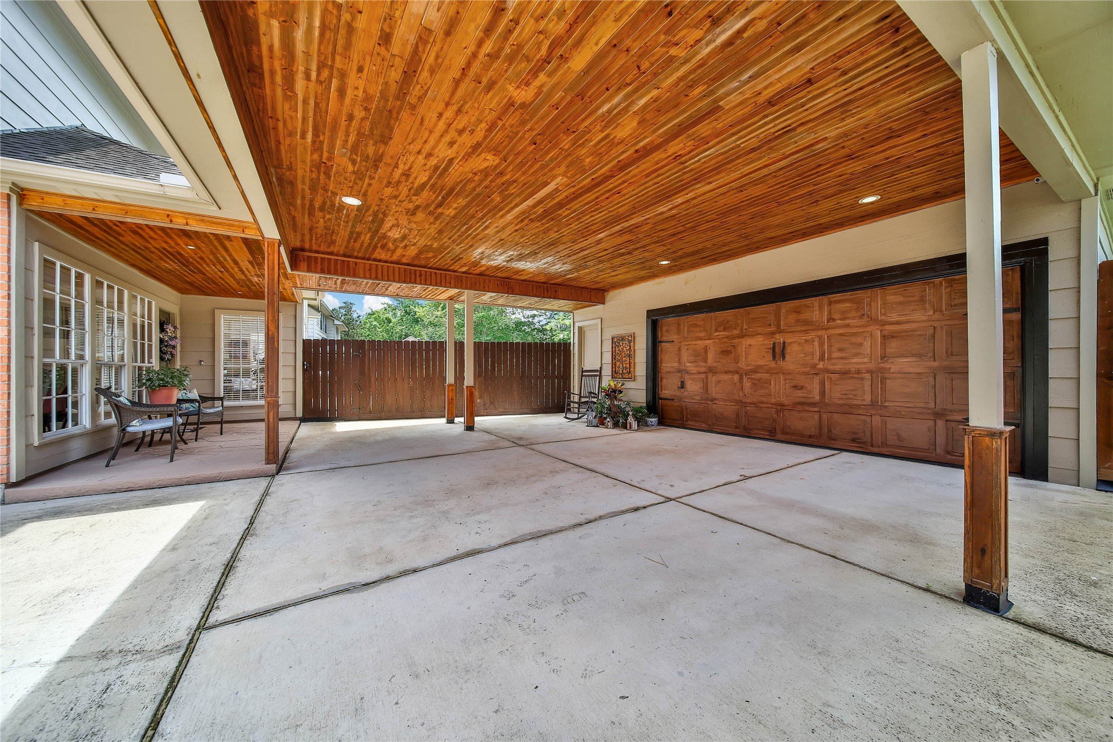 More than covered parkingthe oversized porte-cochere features handsome cedar tongue-and-groove ceilings and doubles as a substantial outdoor entertaining area.