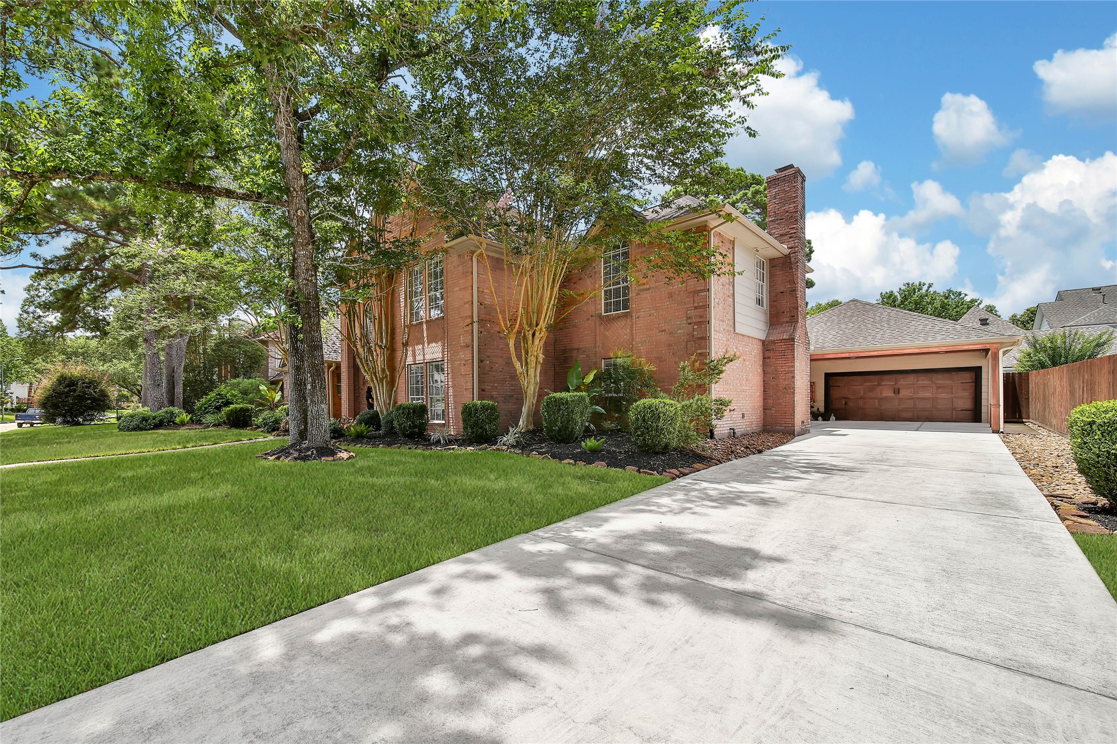 Charming two-story brick home with a well-maintained lawn and mature trees. Features a spacious driveway leading to a detached garage, offering ample parking. Ideal for a cozy suburban lifestyle.
