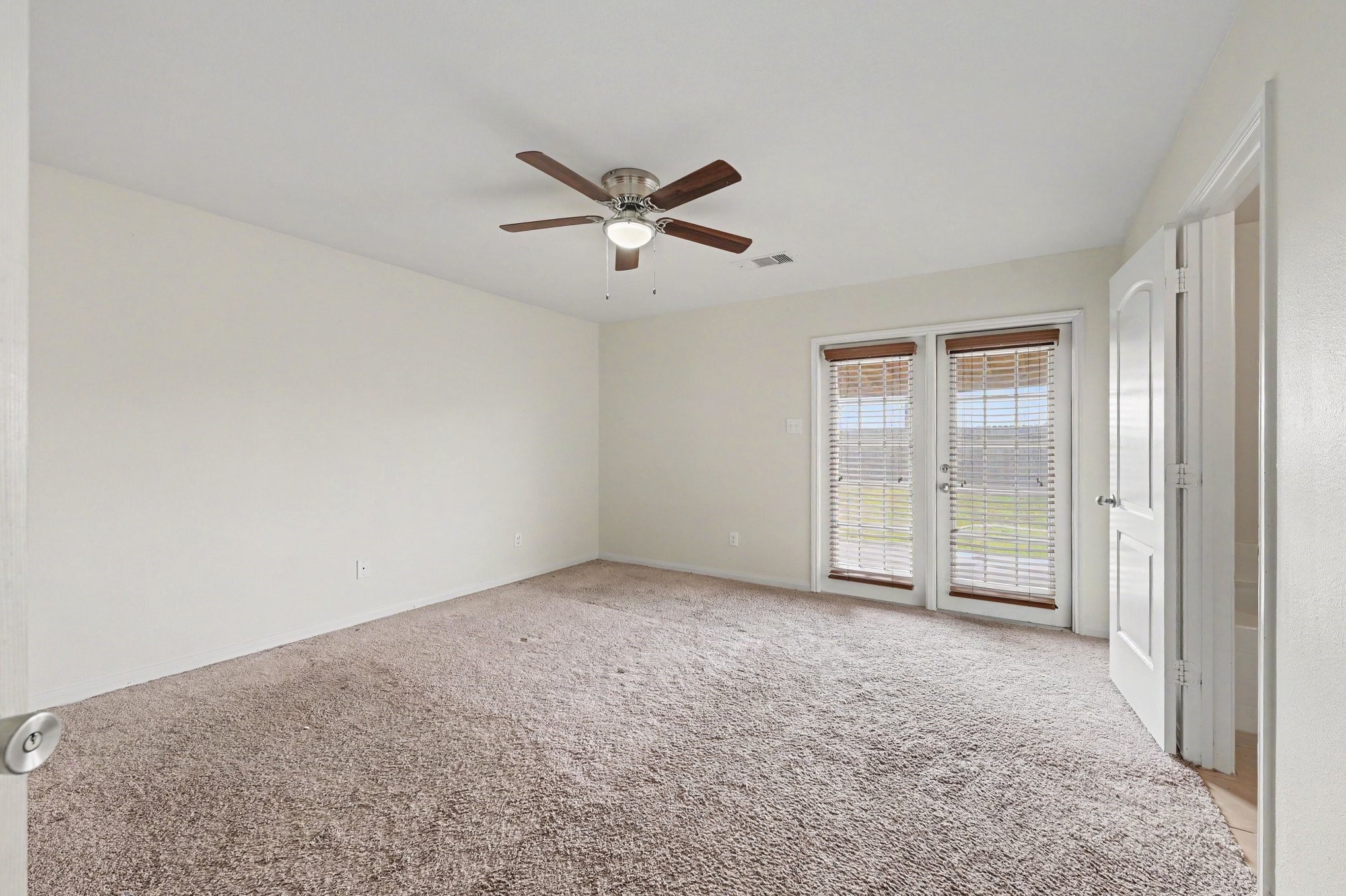 Primary Suite that features large windows with welcoming natural light.