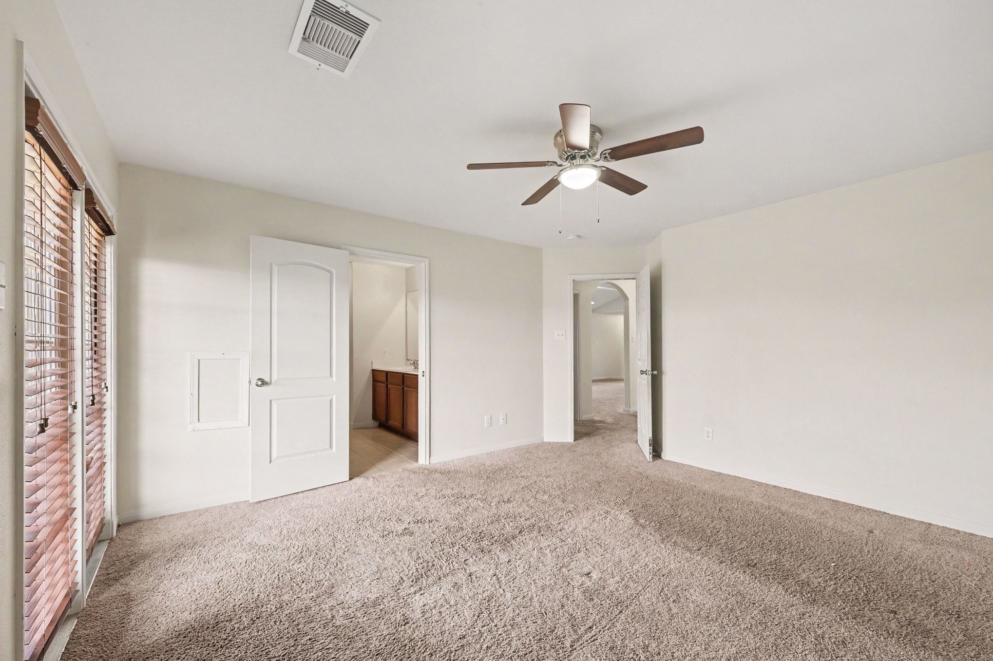 Primary Suite that features large windows with welcoming natural light.