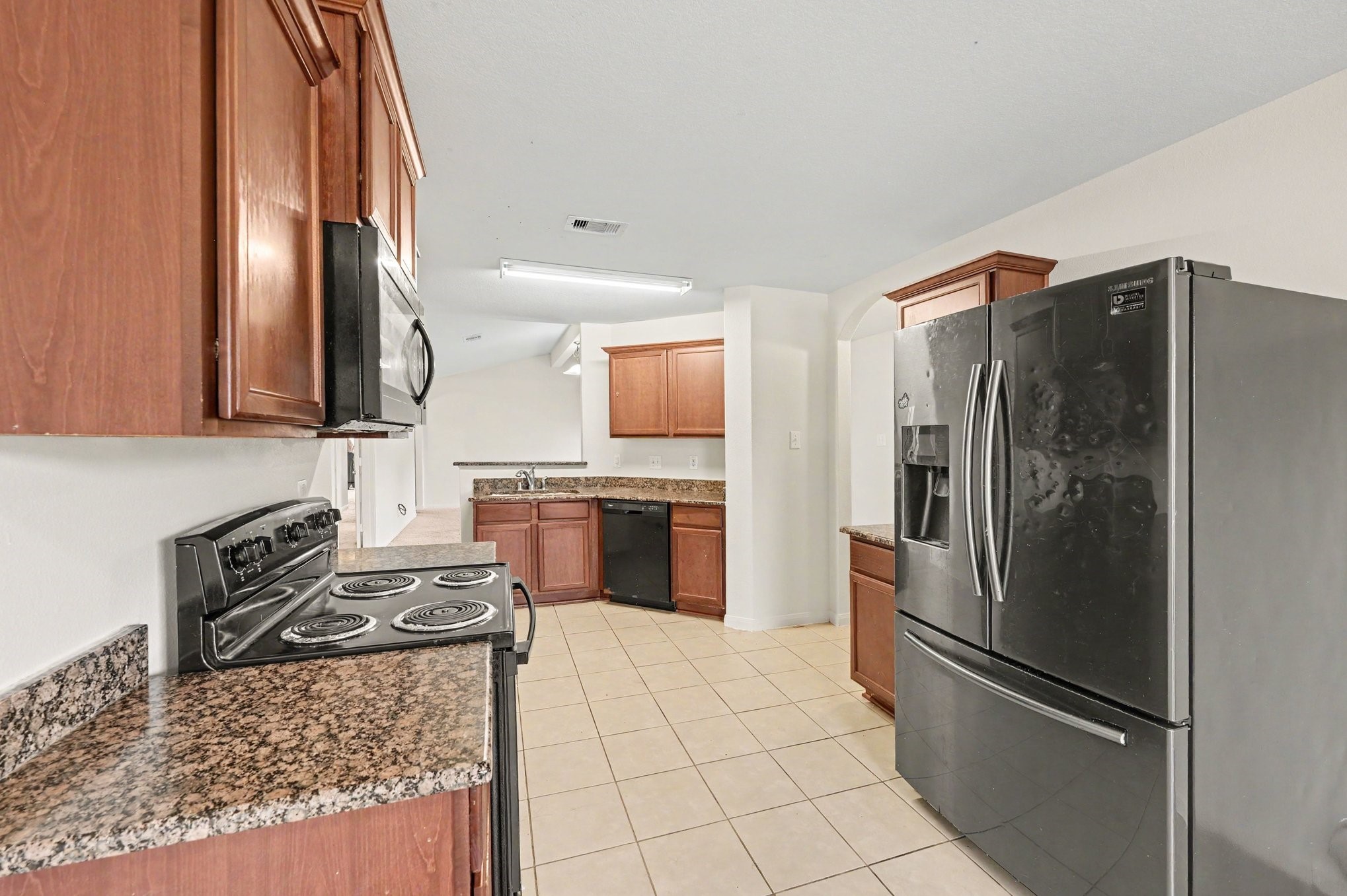 Inviting kitchen with rich wood cabinetry and plenty of counter space.