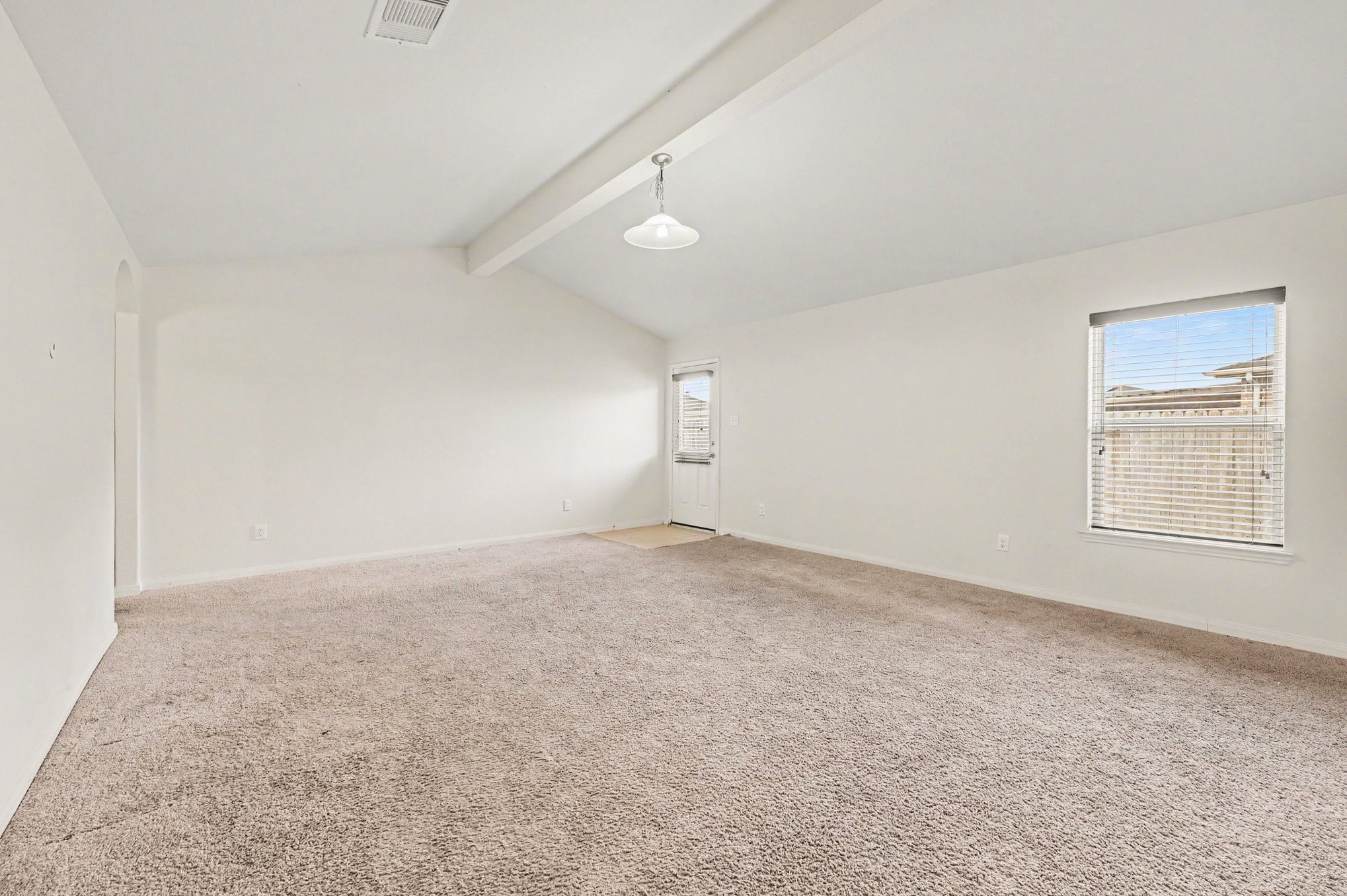 Living Room with vaulted ceilings that bring in plenty of natural light.