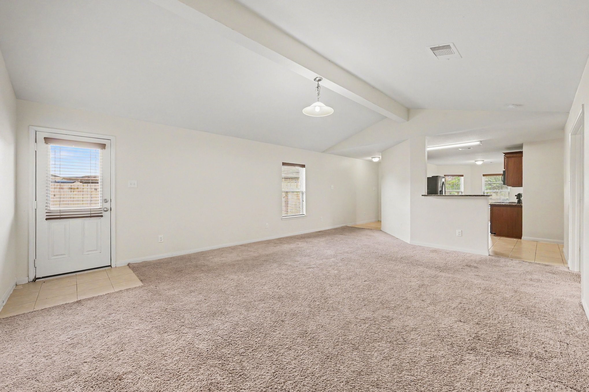 Living Room with vaulted ceilings that bring in plenty of natural light.