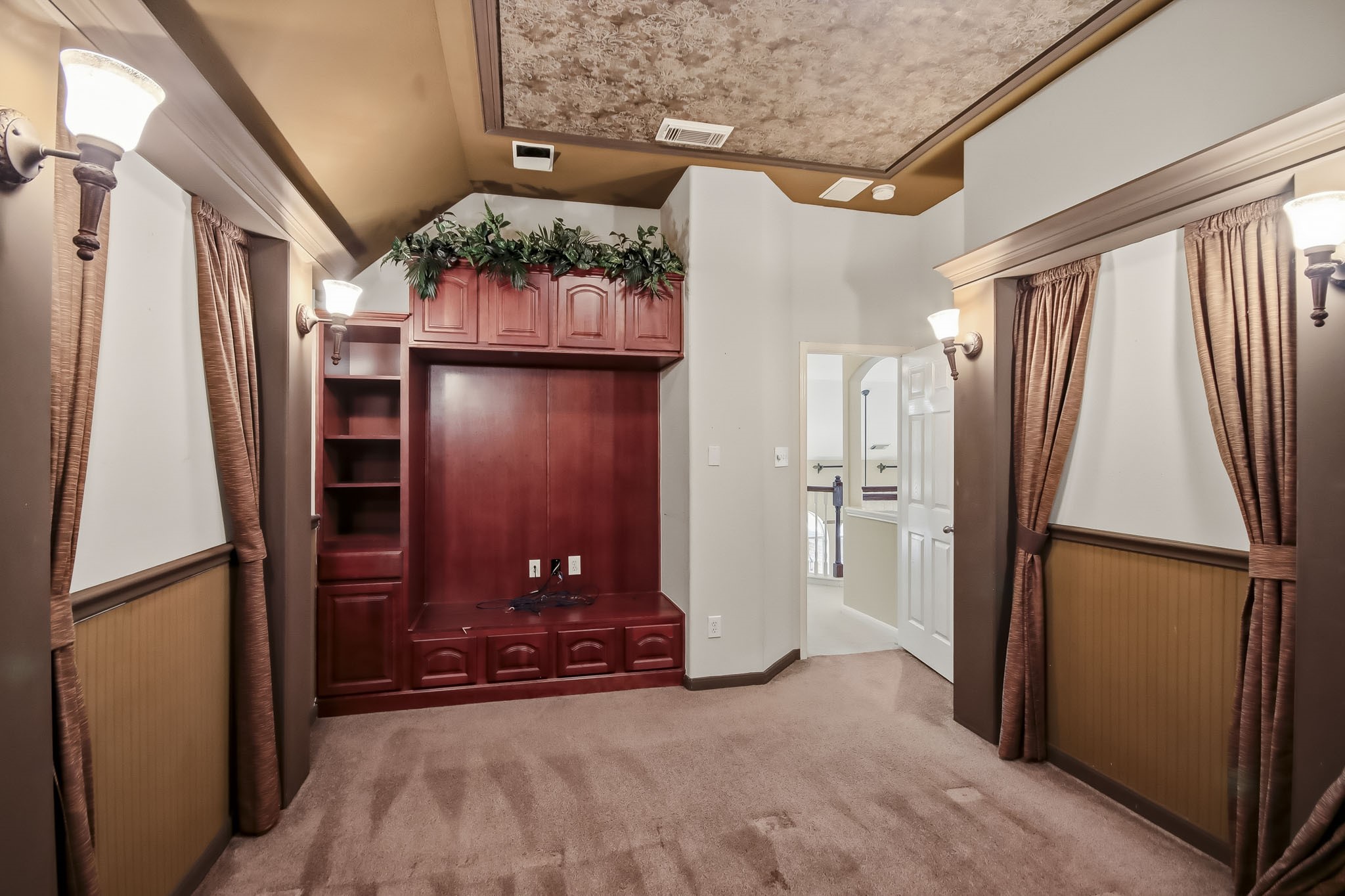 Private movie room featuring dark-tinted walls and a step-down design, creating the perfect theater-like atmosphere to relax and enjoy your favorite movies in the comfort of your own home!