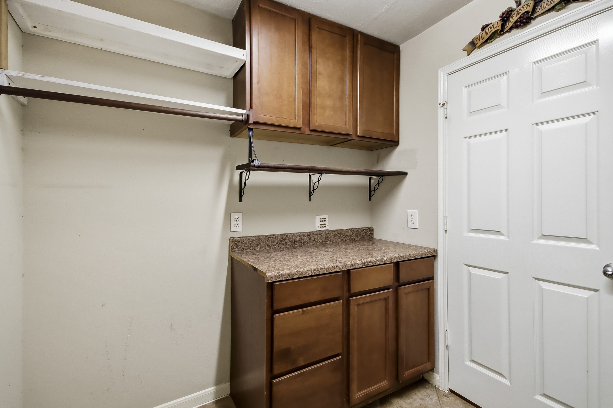 Conveniently located laundry room near the garage, featuring built-in cabinetry for extra storage and organization, making everyday chores a breeze!
