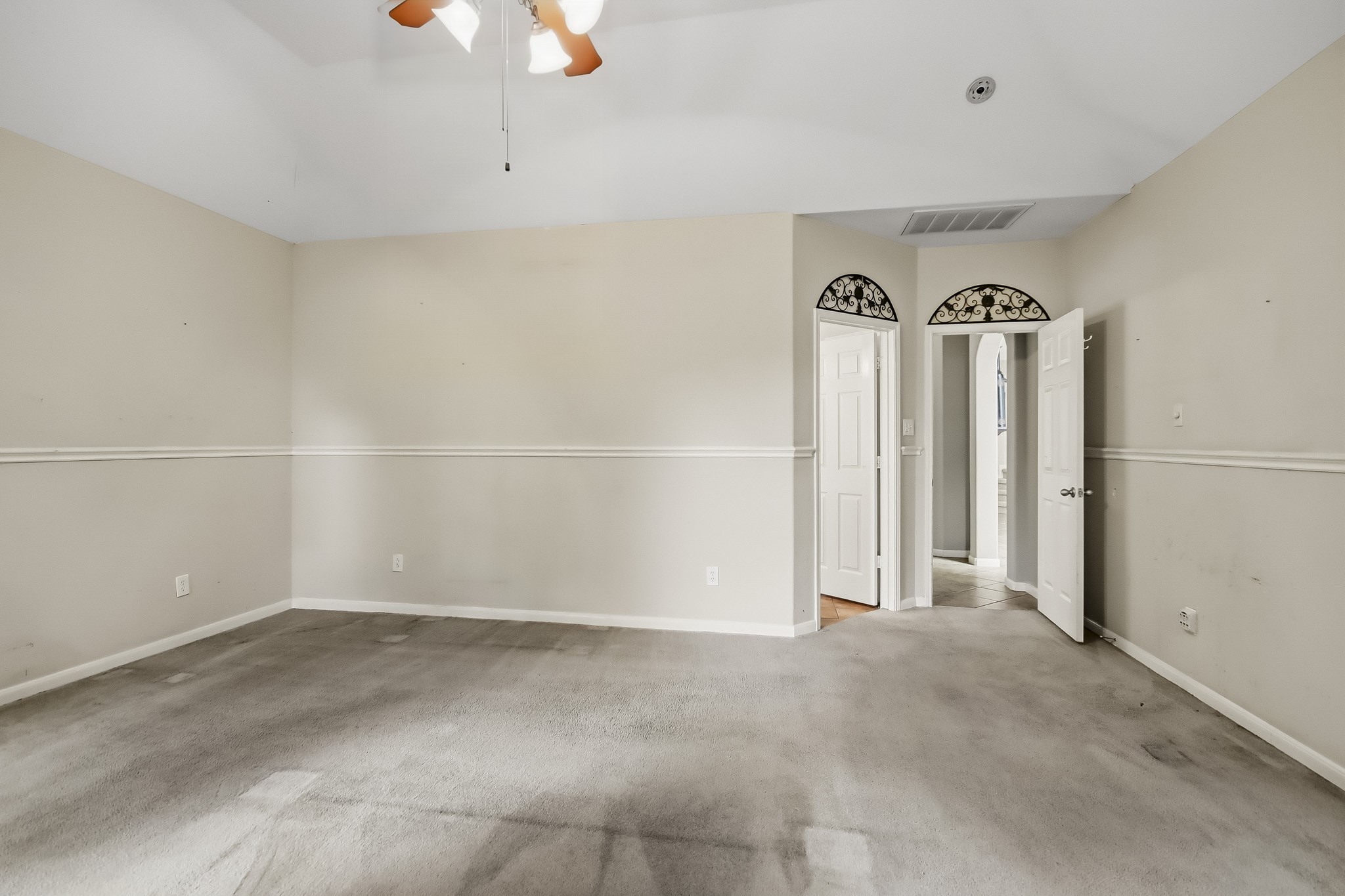 Spacious primary bedroom conveniently located on the first floor, offering comfort, privacy, and easy access to the home's main living areas.