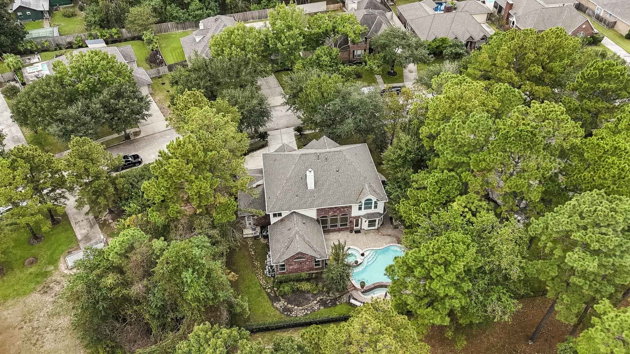 Breathtaking birds-eye view of this beautiful golf course home, surrounded by majestic mature trees and featuring a sparkling private pool, offering the perfect blend of luxury, privacy, and scenic beauty!