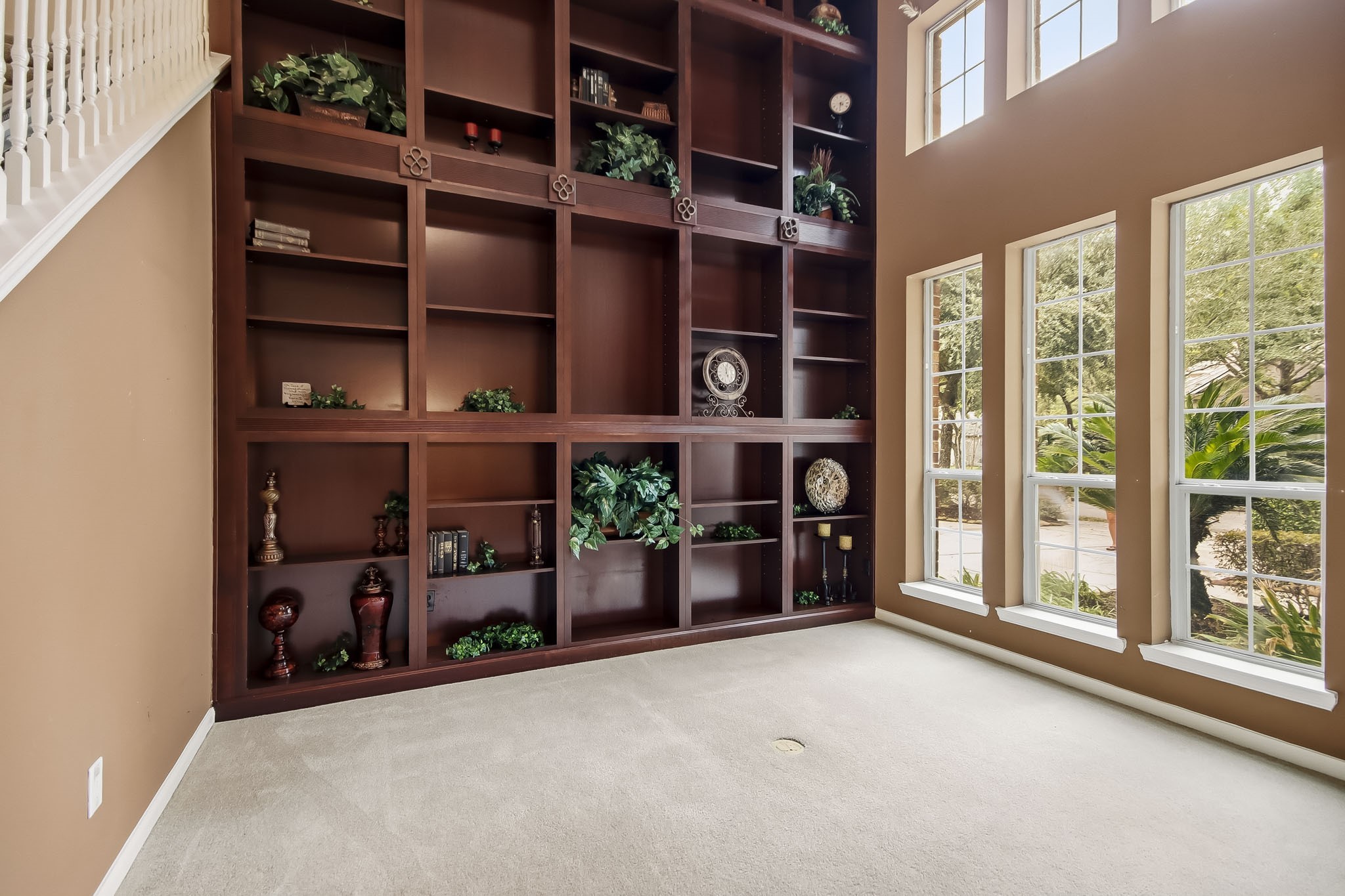 Elegant library featuring stunning floor-to-ceiling custom built-in bookshelves, offering a sophisticated space for reading, working, or relaxing.