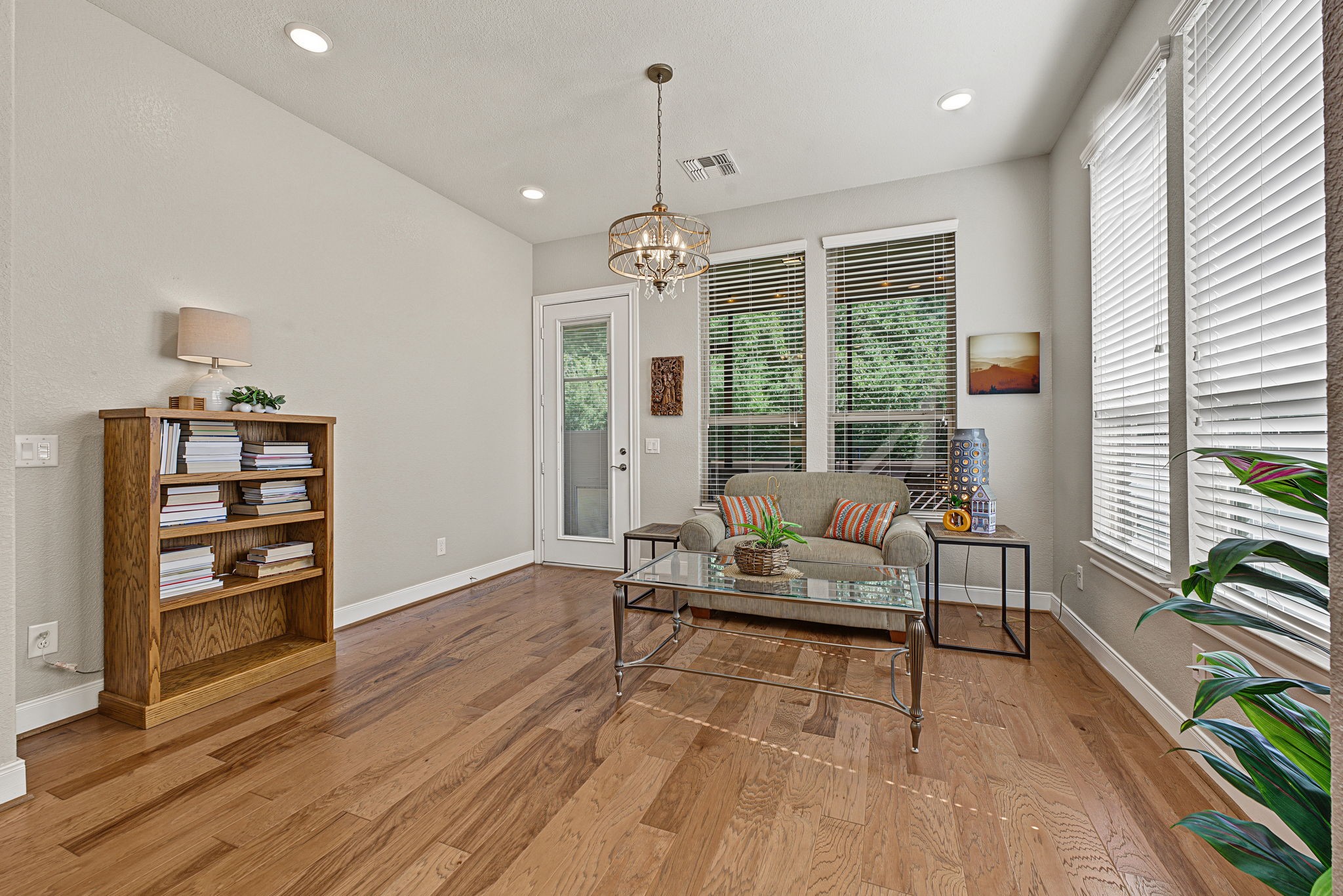 The Sunroom is bathed in natural lighting. Access to the backyard (with an additional doggie door) to the screened-in back patio.