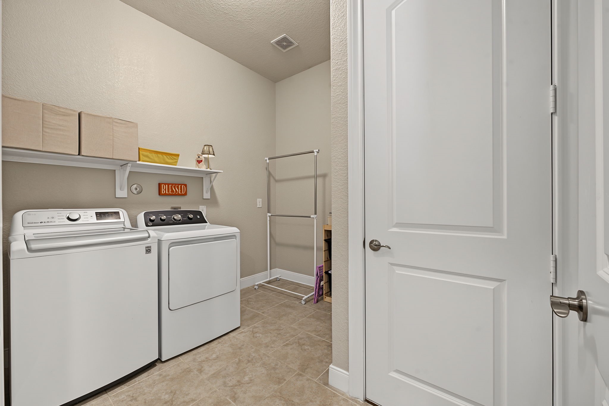Spacious laundry room with extra space available for a fridge or storage. Mechanicals to HVAC are in that closet.