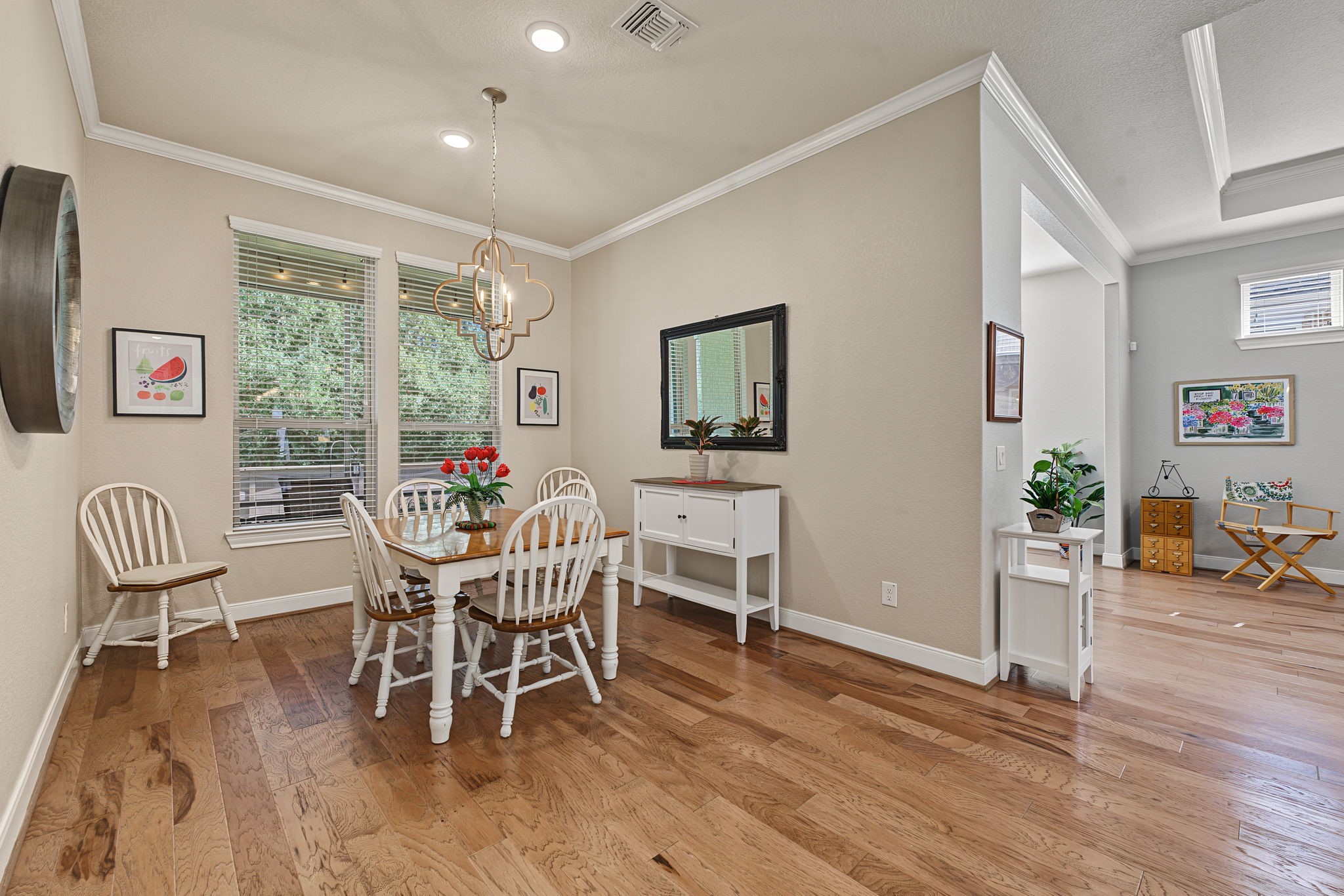 Open to the kitchen and family room, the spacious breakfast area feels like its own distinct space, with a peaceful view of the trees behind the home.