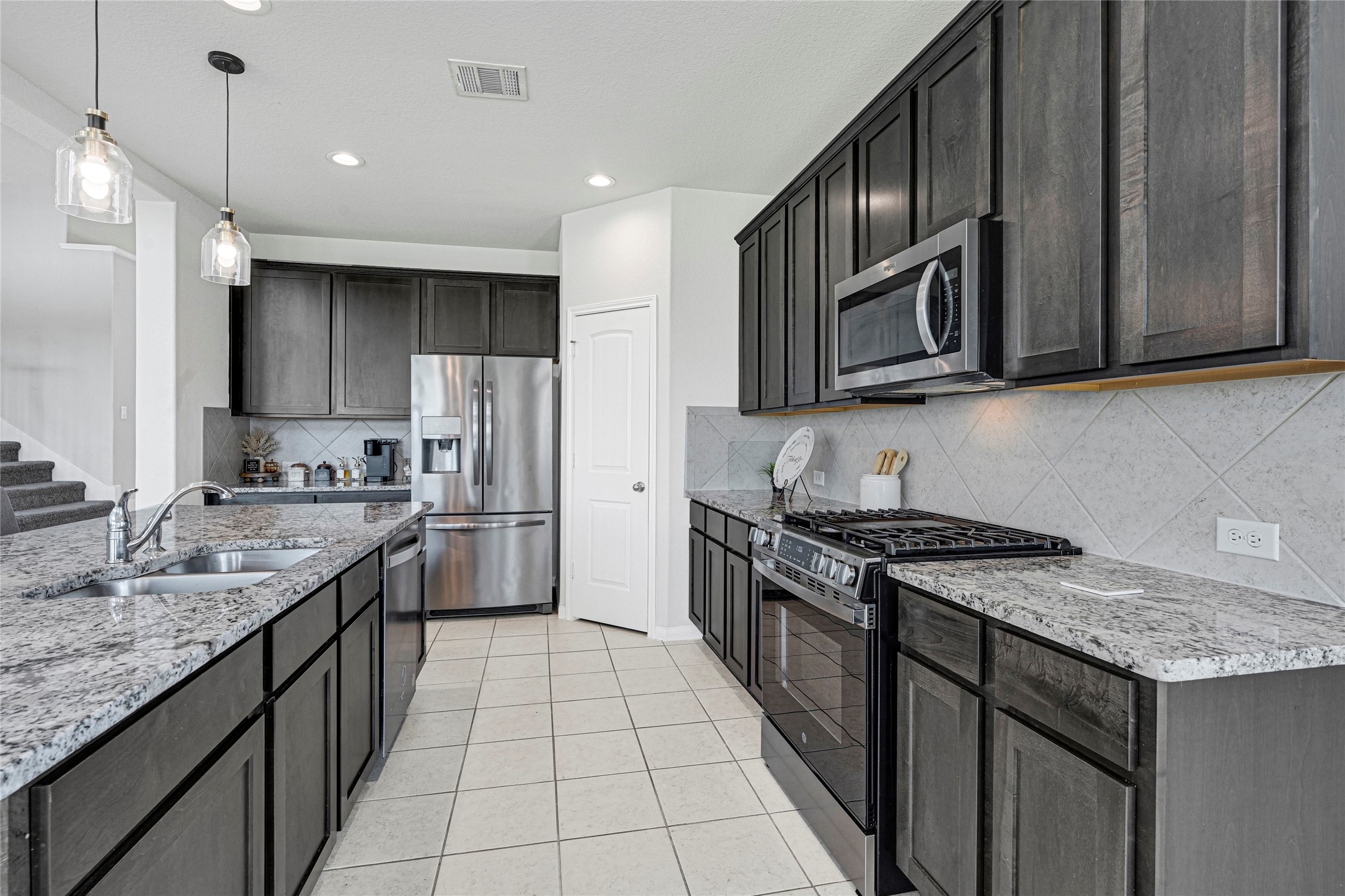 Lots of Granite Countertops, Island & Cabinets with a Pantry.  Coffee Bar tucked next to Refrigerator.  Kitchen Appliances stay.