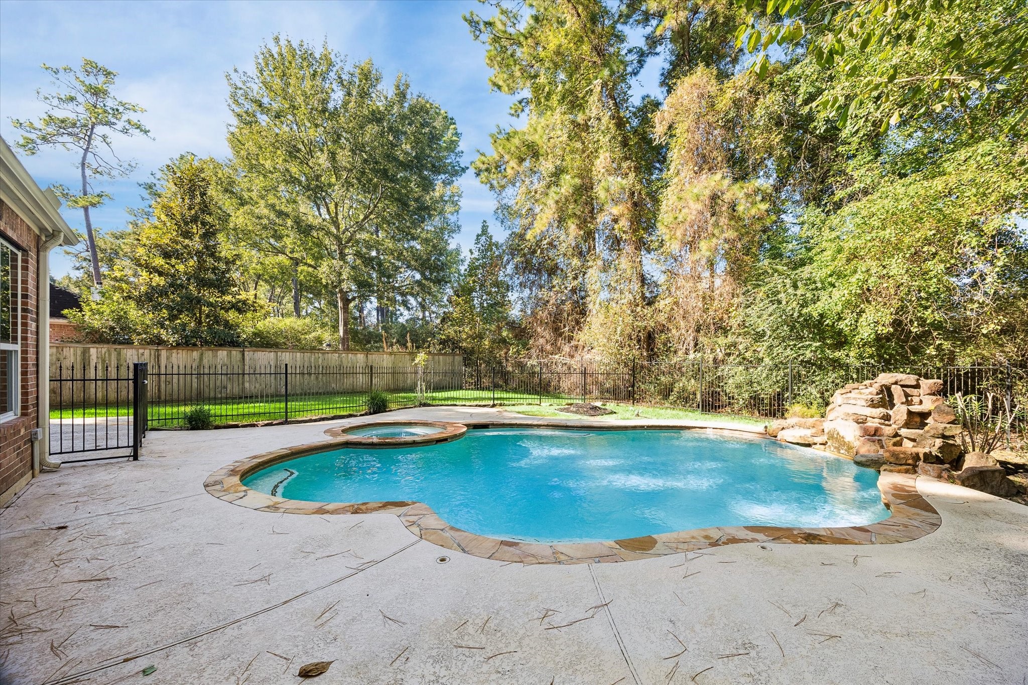 Decorative rock features add a natural, eye-catching accent to the pool area, enhancing the backyards overall appeal.