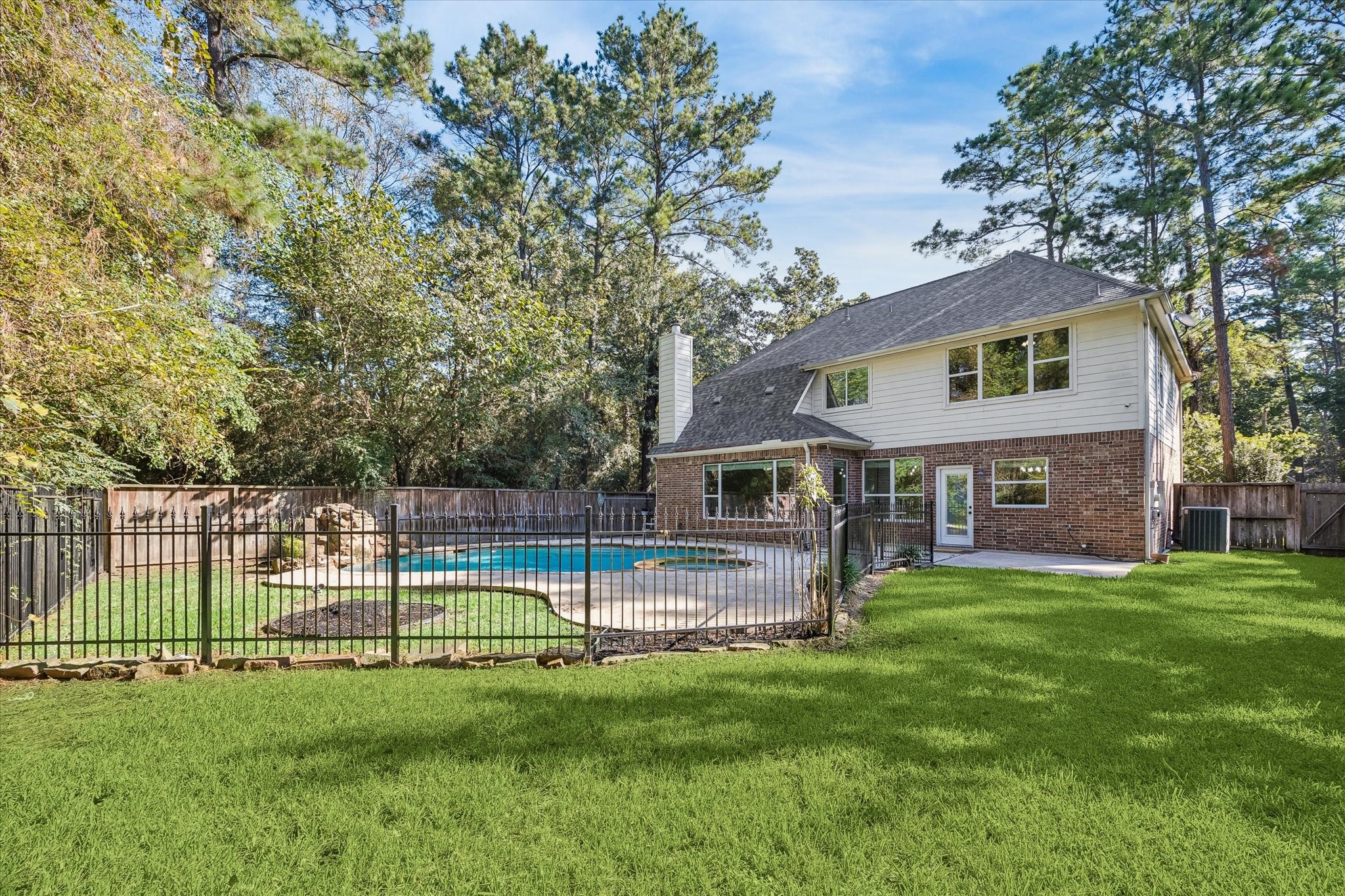 This rear view of the home truly showcases the generous lot size!