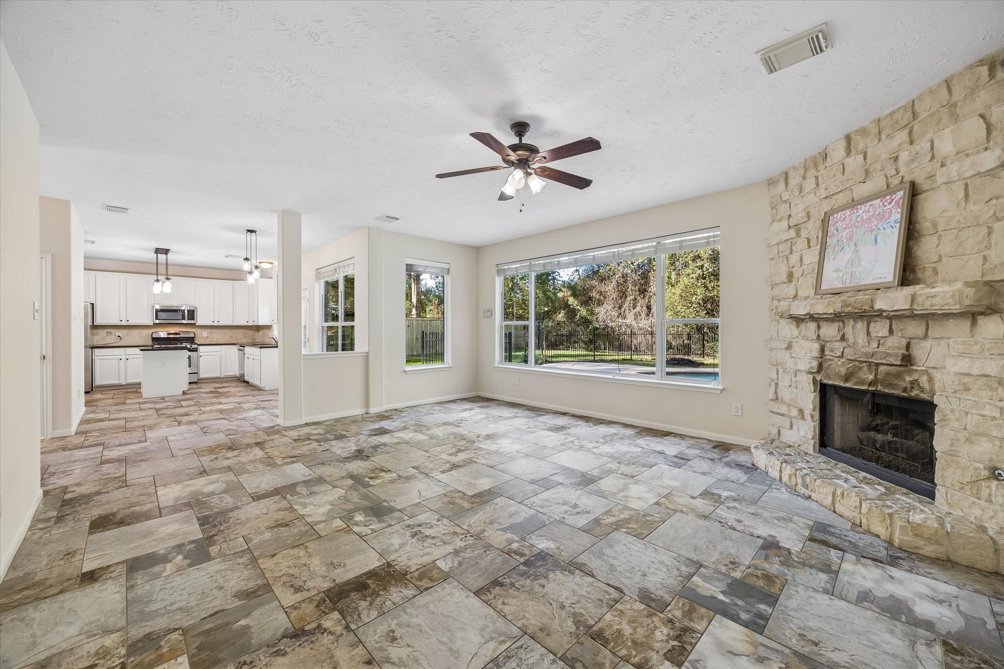 The open-concept floor plan seamlessly connects the living area to the kitchen, creating a spacious and inviting layout.