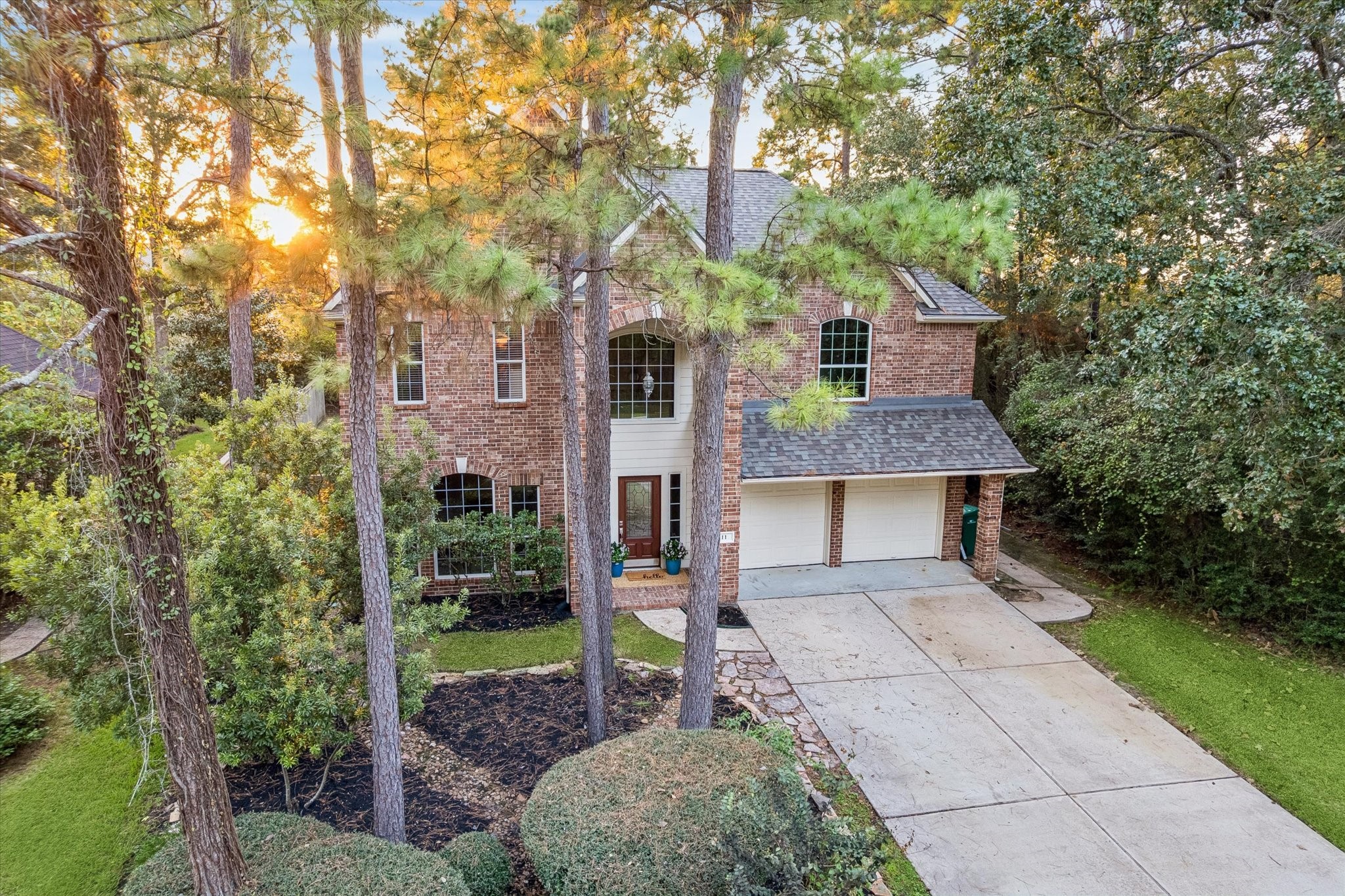 Mature trees surround the home, adding natural beauty, shade, and a sense of privacy.