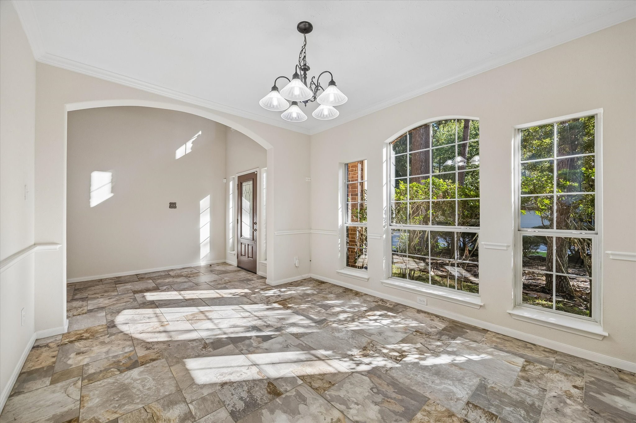 Another view of the formal dining room highlighting expansive windows that fill the space with abundant natural light. Nearly all windows have been replaced and are double paned.