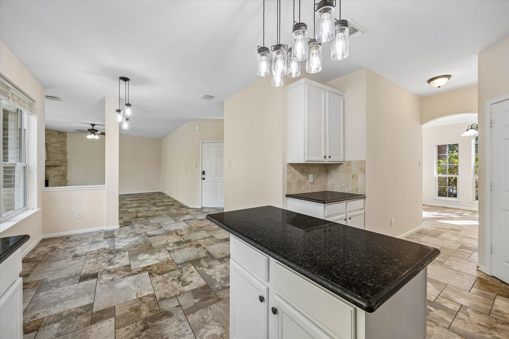 The open-concept layout seamlessly connects the kitchen to the surrounding living and dining spaces, creating a spacious, functional flow throughout the home.