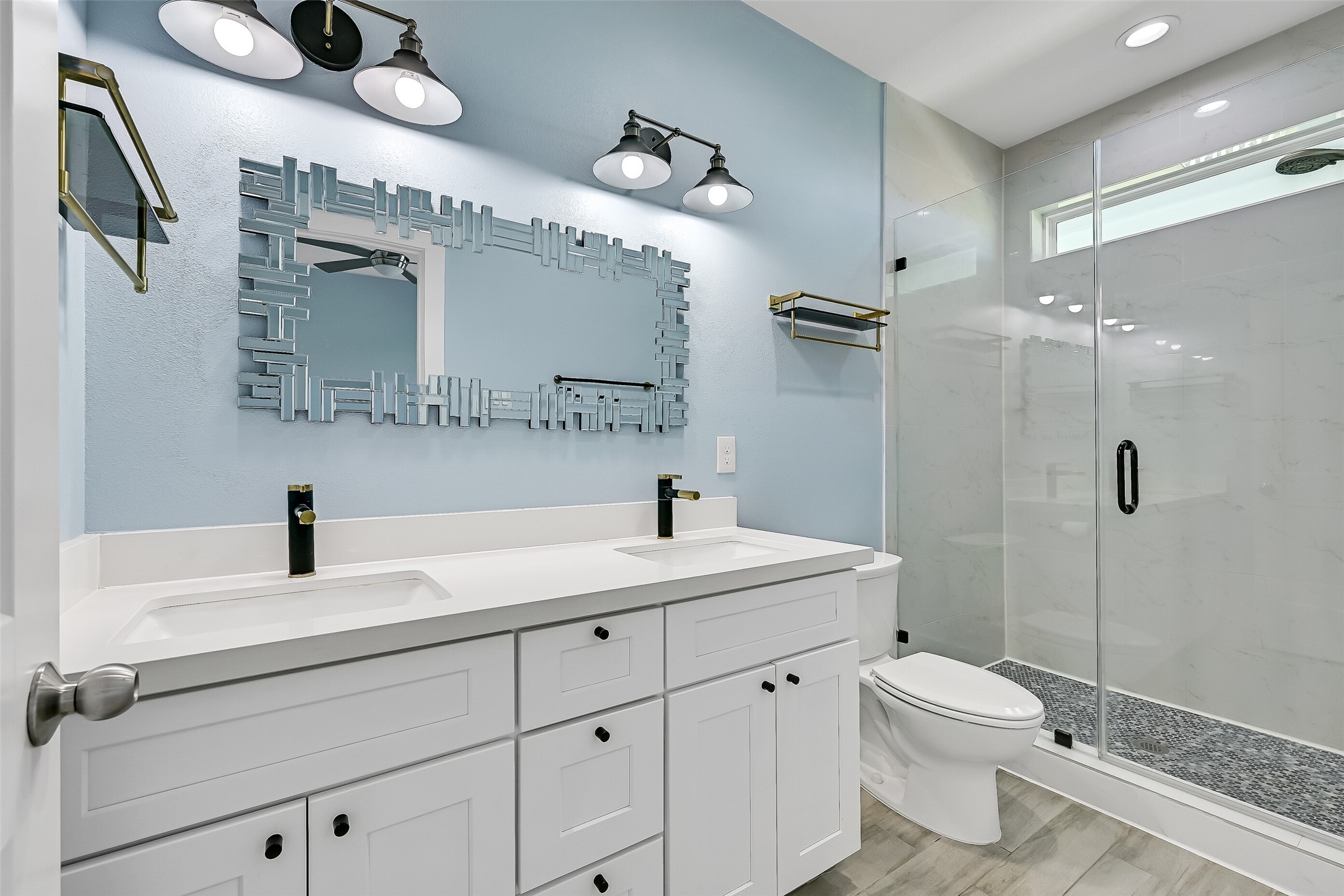 The primary bathroom is complete with quartz countertops, double vanities and a walk-in shower.