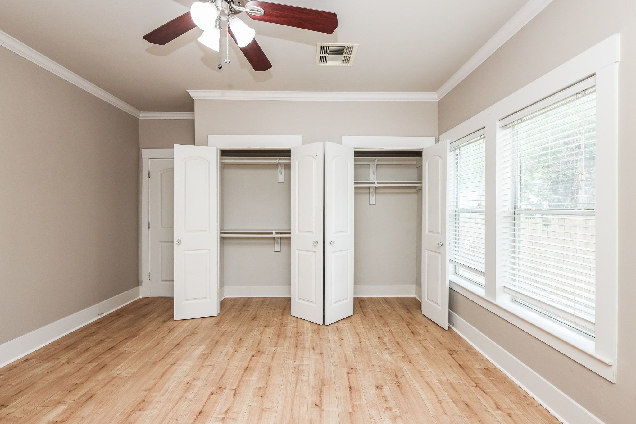 Primary bedroom featuring two built-in closets for ample storage.