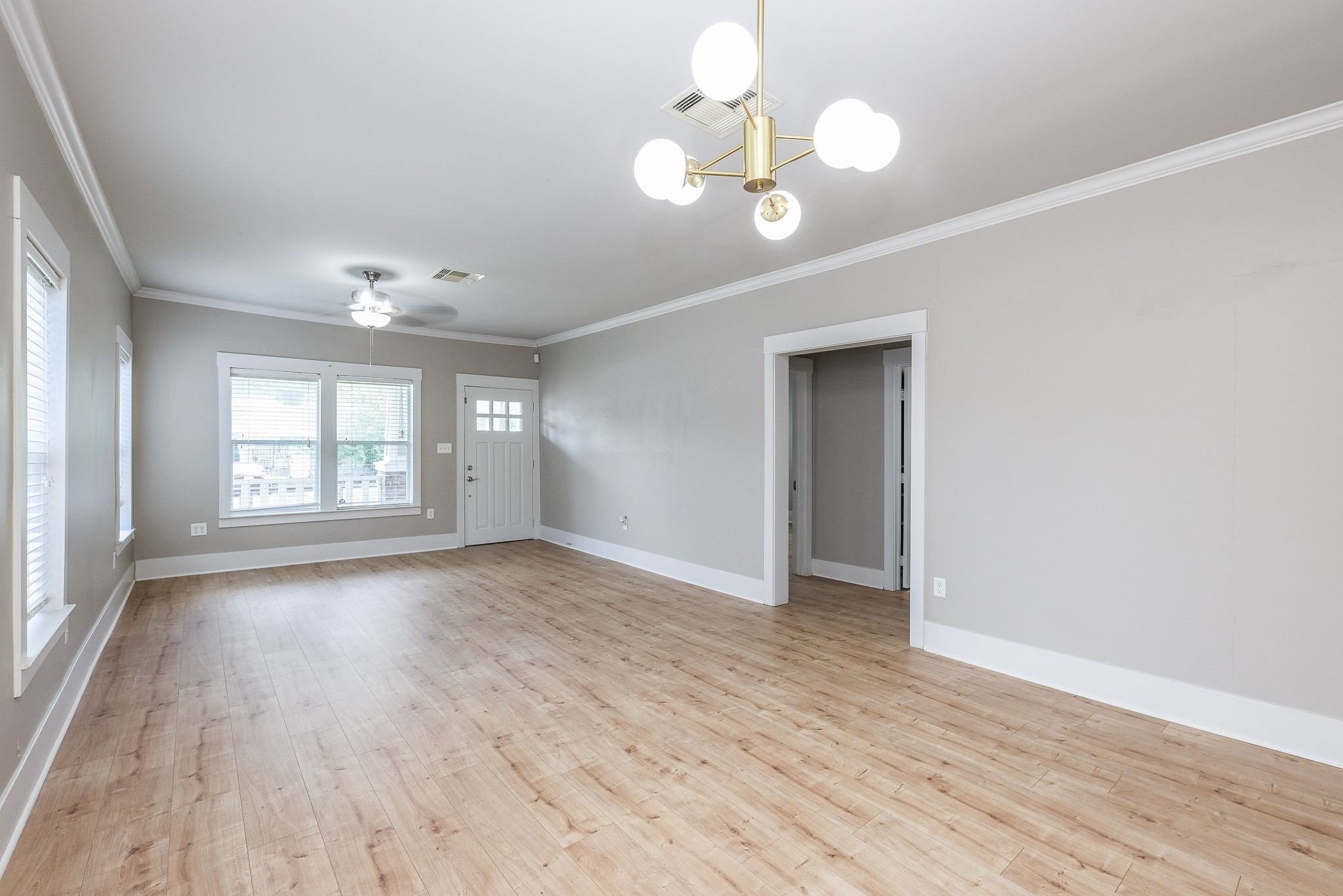 Light-filled room showcasing recently installed vinyl plank flooring. Light-filled room showcasing recently installed vinyl plank flooring.