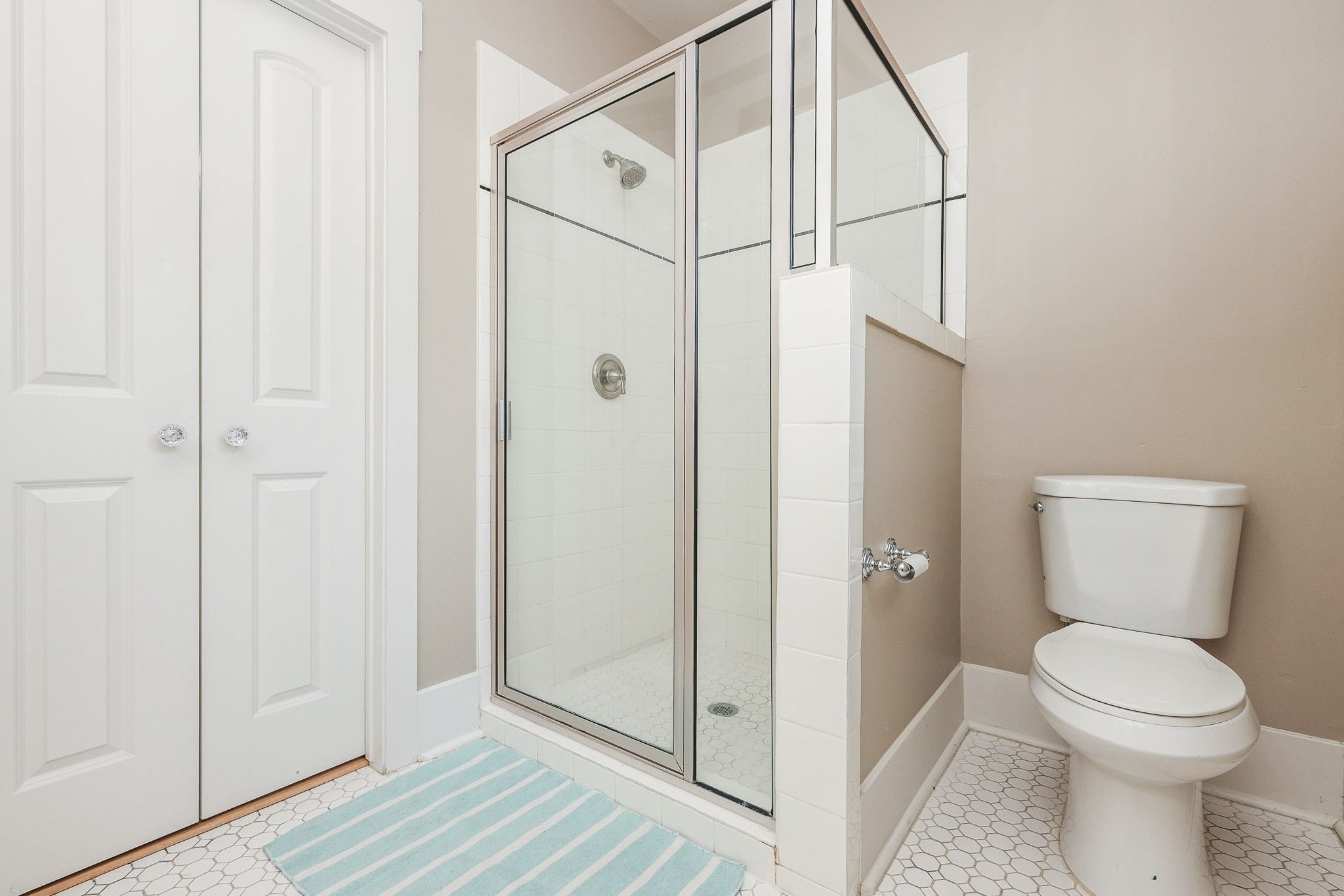 Primary bathroom featuring a glass-enclosed shower.
