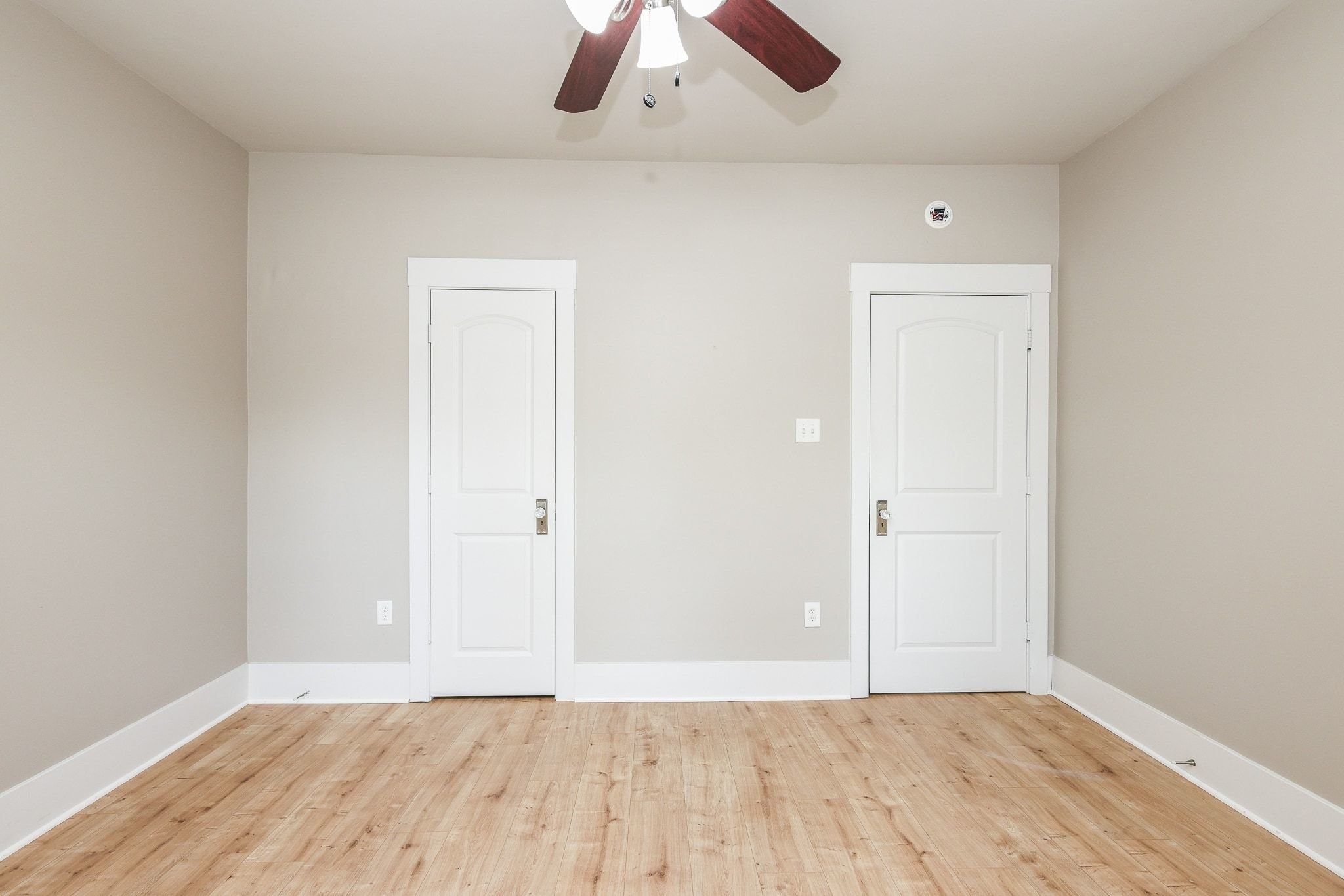Bedroom with closet and ceiling fan.