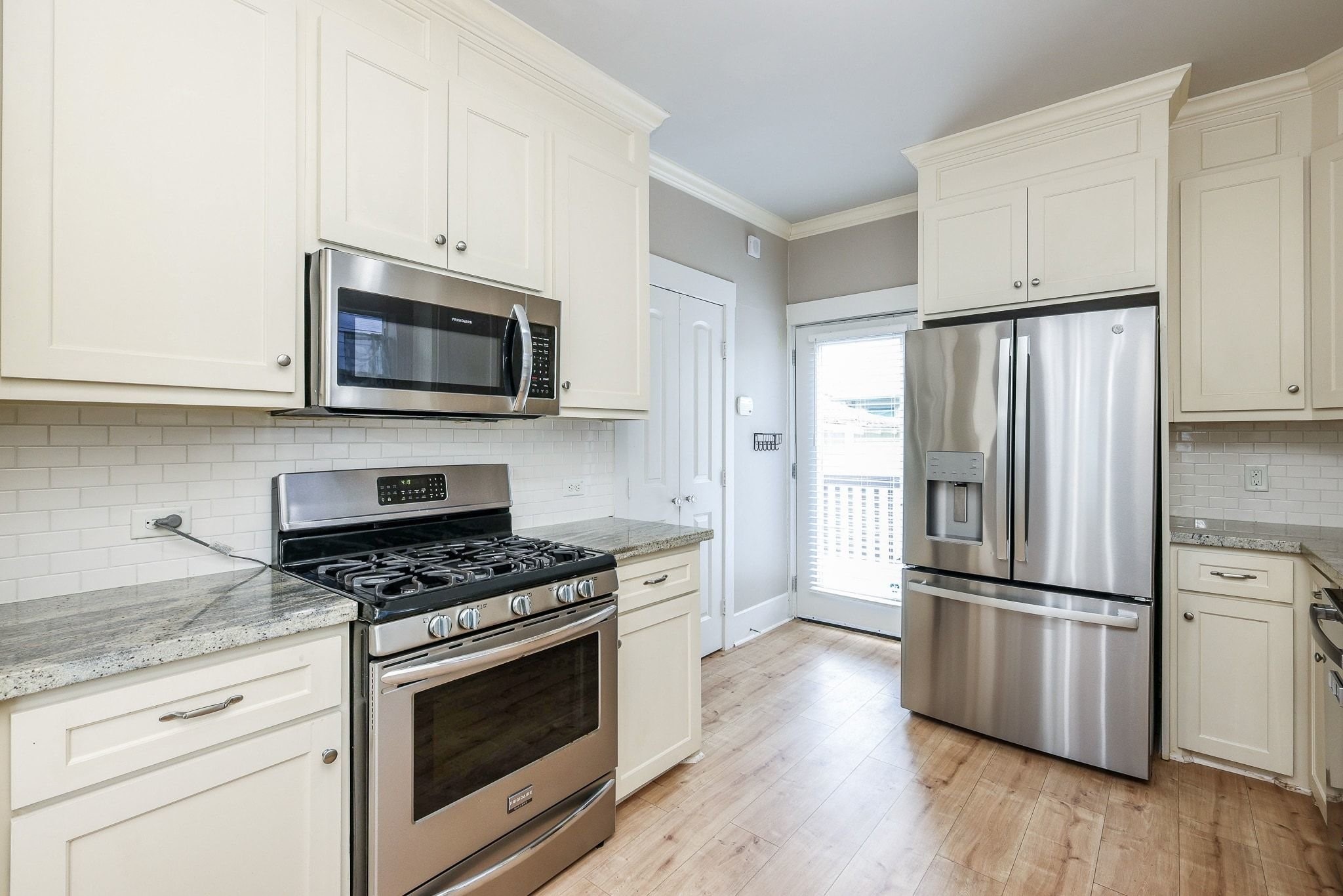 This kitchen has tons of natural light with this perfect situated back door. This kitchen has tons of natural light with this perfect situated back door.