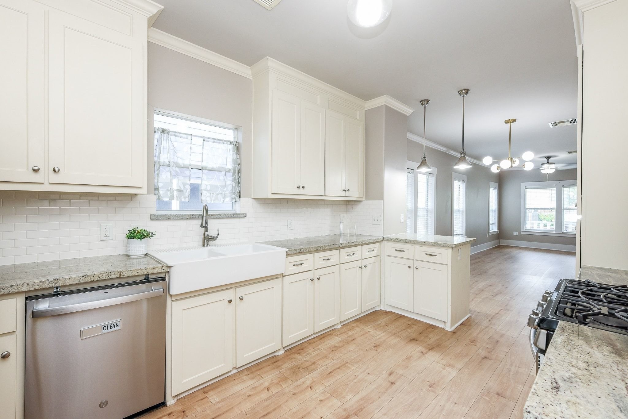 Kitchen made for your inner chef, featuring elegant off-white cabinets, sleek countertops, and a chic subway tile backsplash. Kitchen made for your inner chef, featuring elegant off-white cabinets, sleek countertops, and a chic subway tile backsplash.