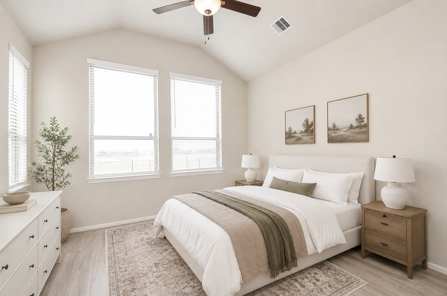 the primary bedroom features beautiful windows highlighting the green space outdoors