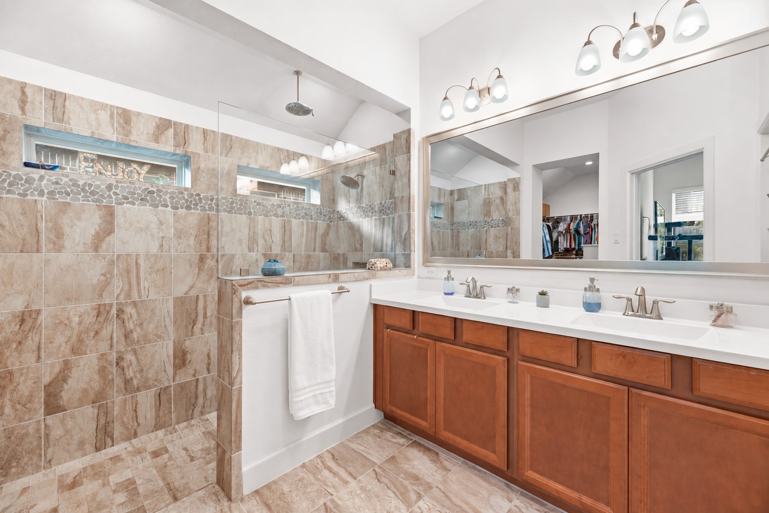 Luxurious primary bathroom featuring a spacious tiled floor to celling walk-in super shower.