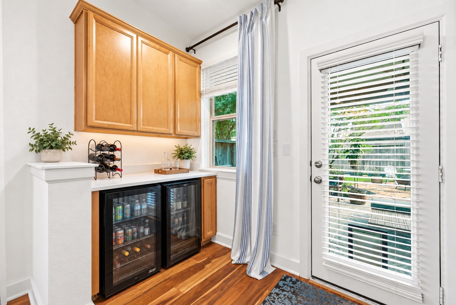 Quaint corner mini bar set up with room for 2 mini drink fridges and storage above.