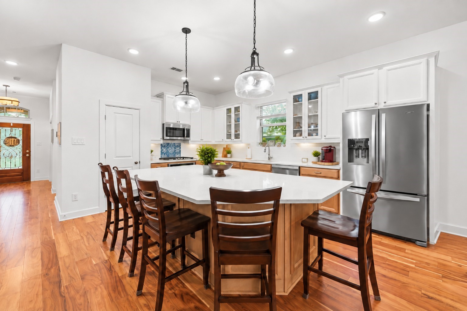 Spacious kitchen featuring a large island with plenty of seating and modern fixtures.