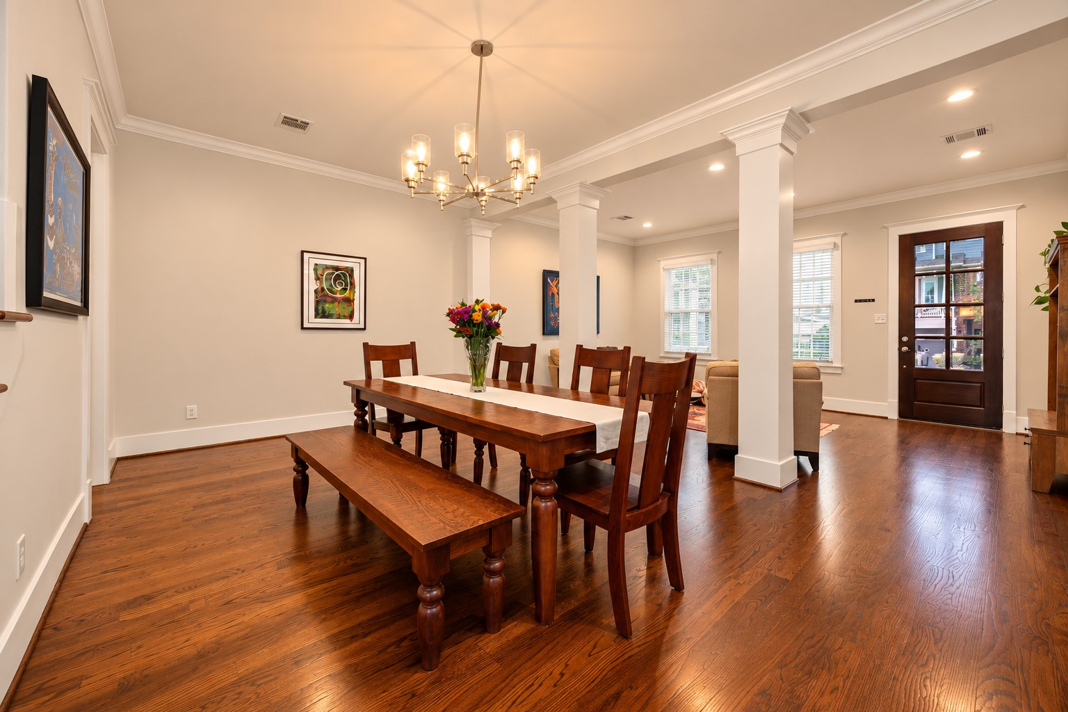 Dedicated dining room features hardwood floors, decorative chandelier & an open connection to the front living room.