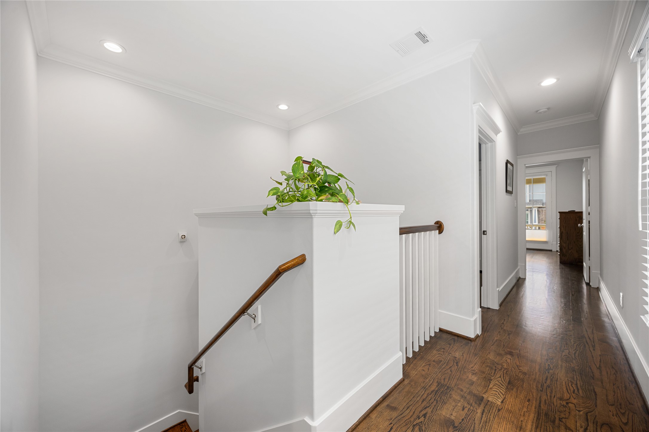Upstairs with hardwood floors connects the bedrooms, bathrooms.