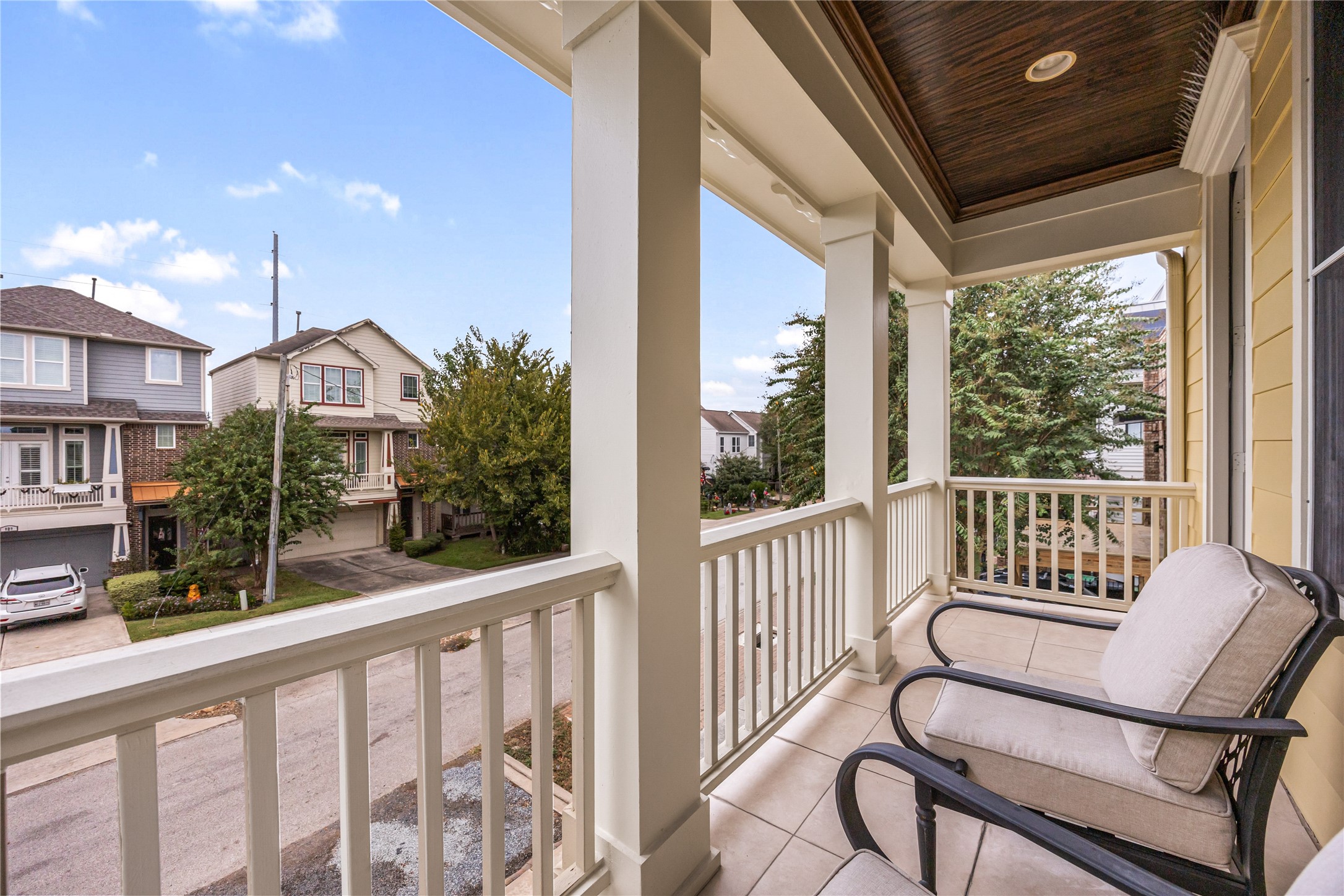 Covered upstairs balcony provides an inviting outdoor retreat with views of the surrounding Heights neighborhood.