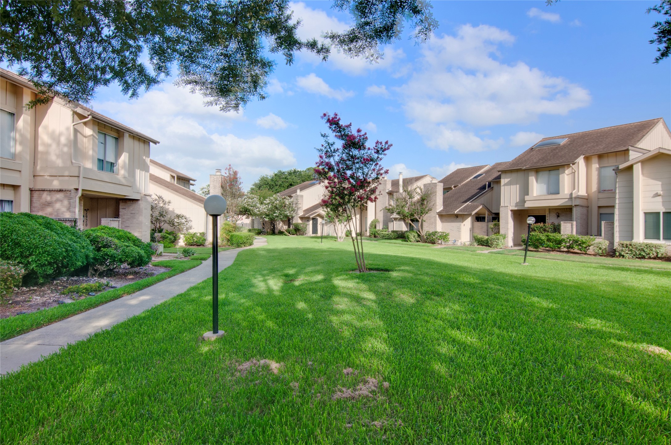 Charming townhomes with well-maintained landscaping and a serene, spacious green courtyard perfect for leisurely strolls.