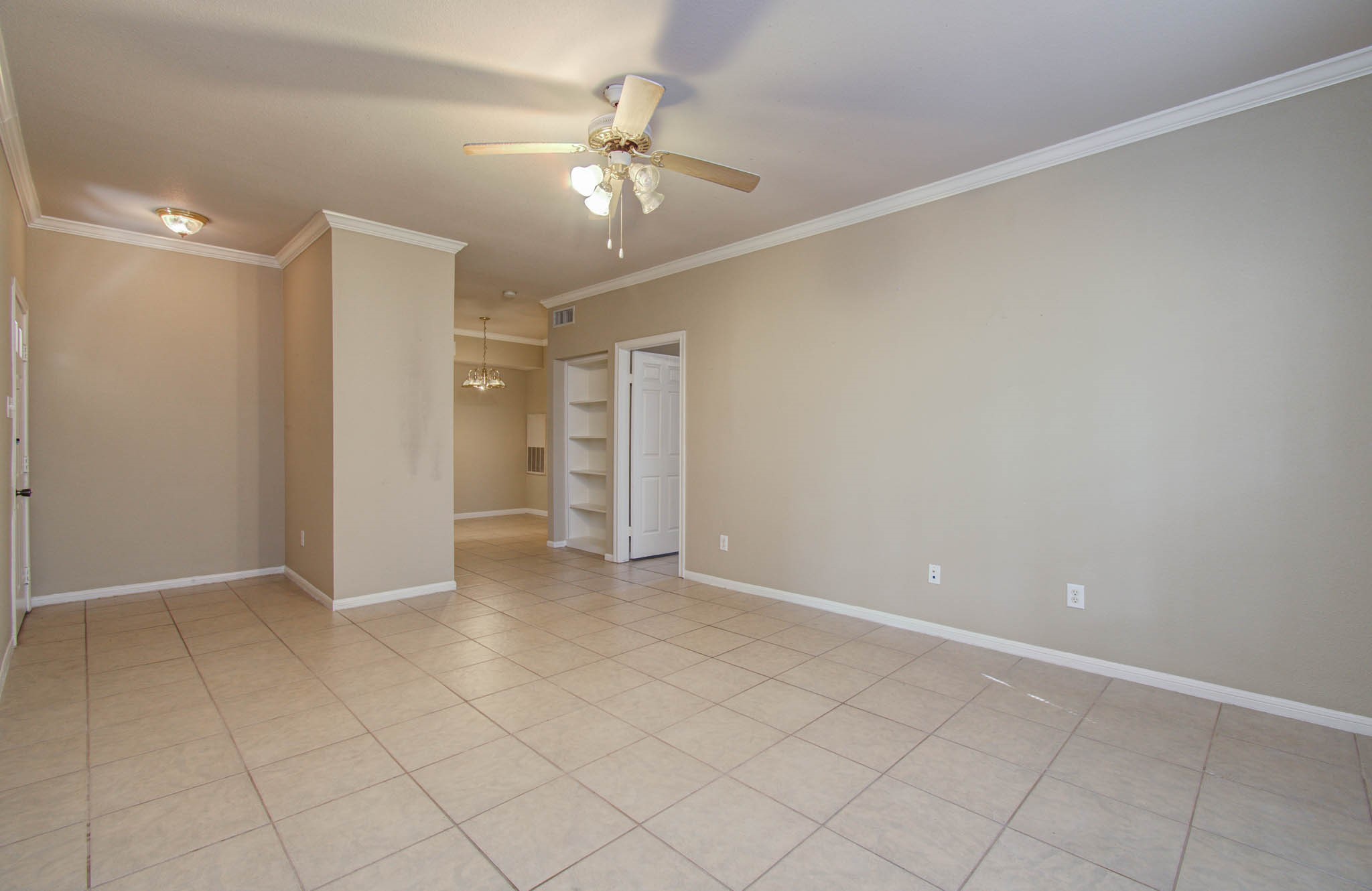 Another view of spacious living room featuring built-in shelving
