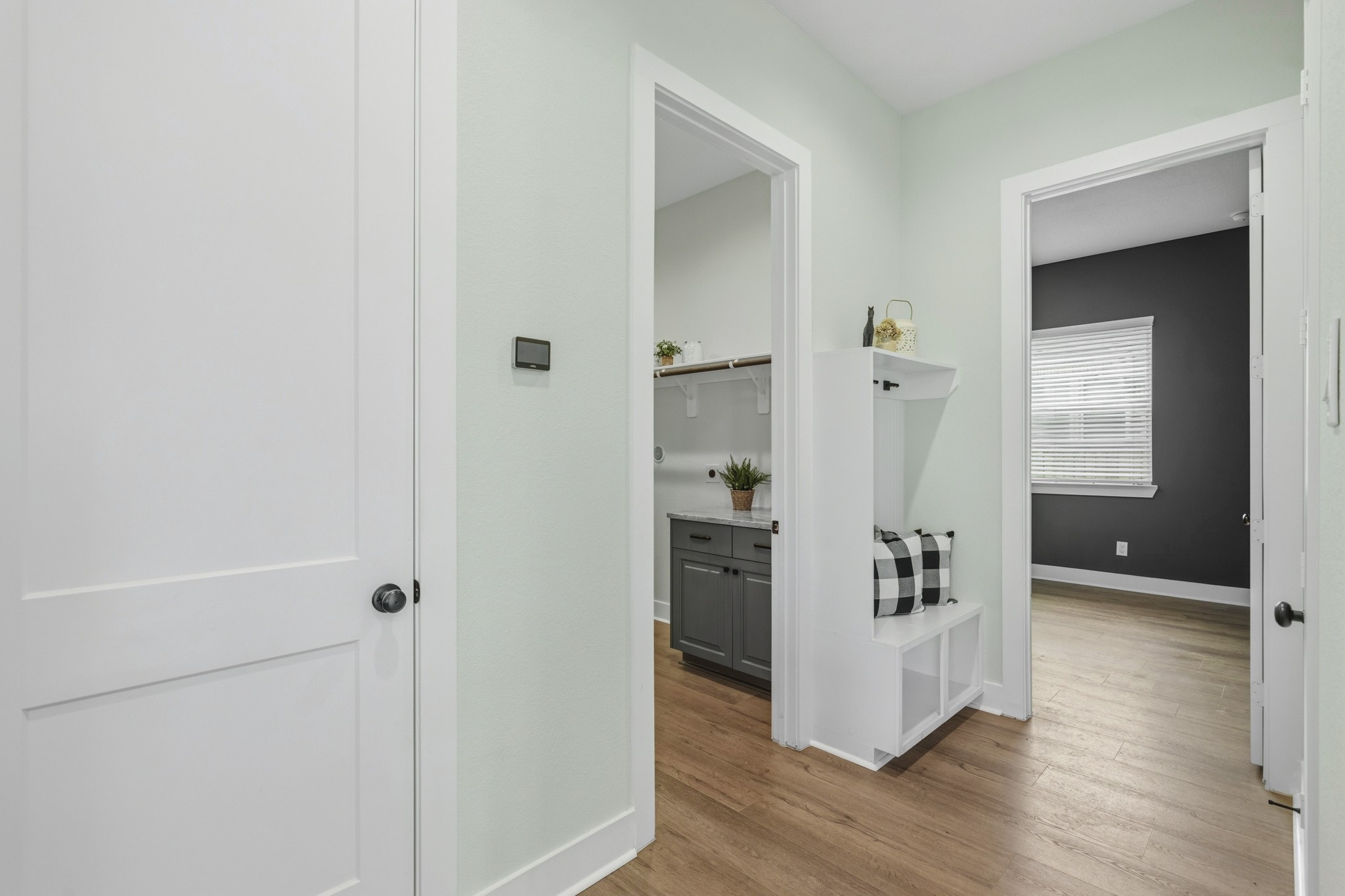 Located off the access to the Utility Room and the 2-car Garage sits this well-appointed Mud Room that provides a well desired drop zone for coats, backpacks, and keys. The closed door to the left leads to the Powder Room, followed by the Laundry Room, and then the Media Room.